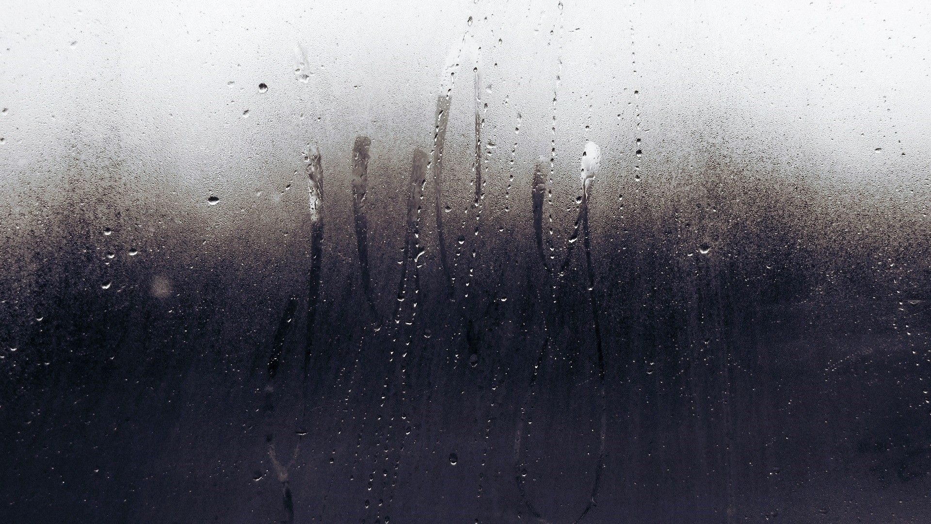 A black and white photo of rain on the window - Rain