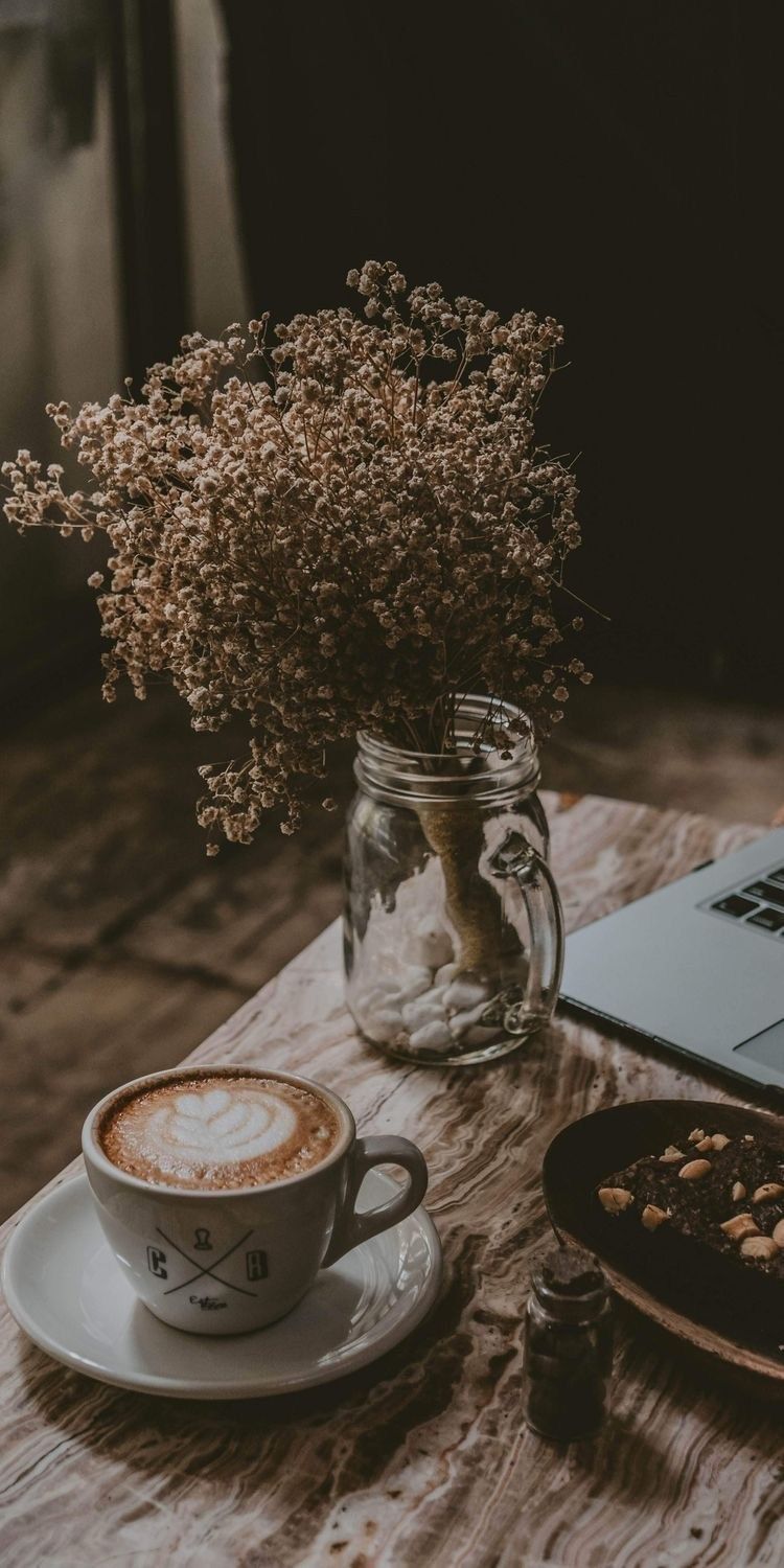 Coffee, laptop, and cookies on a table. - Coffee