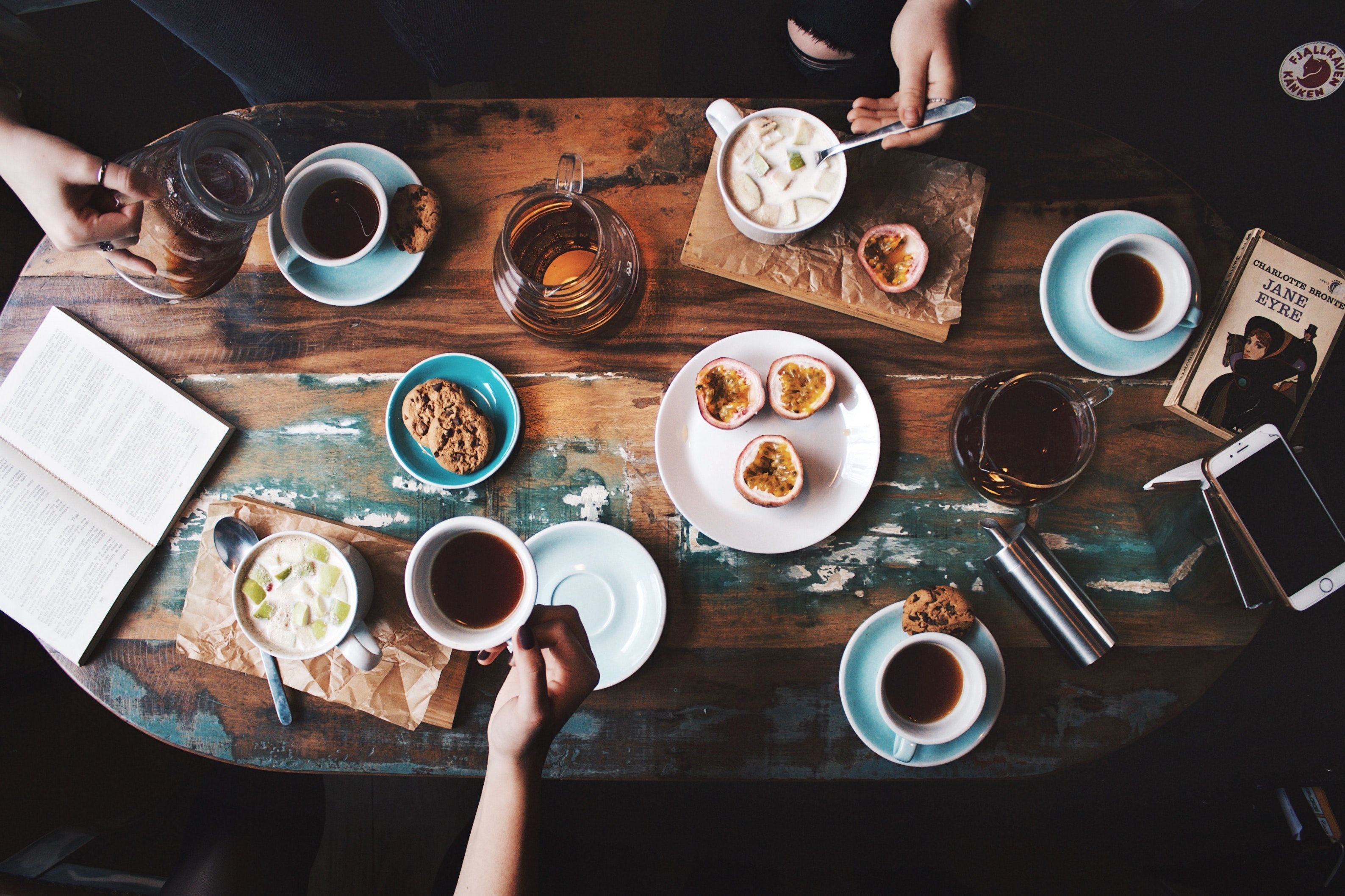 A table with plates of food and drinks - Coffee