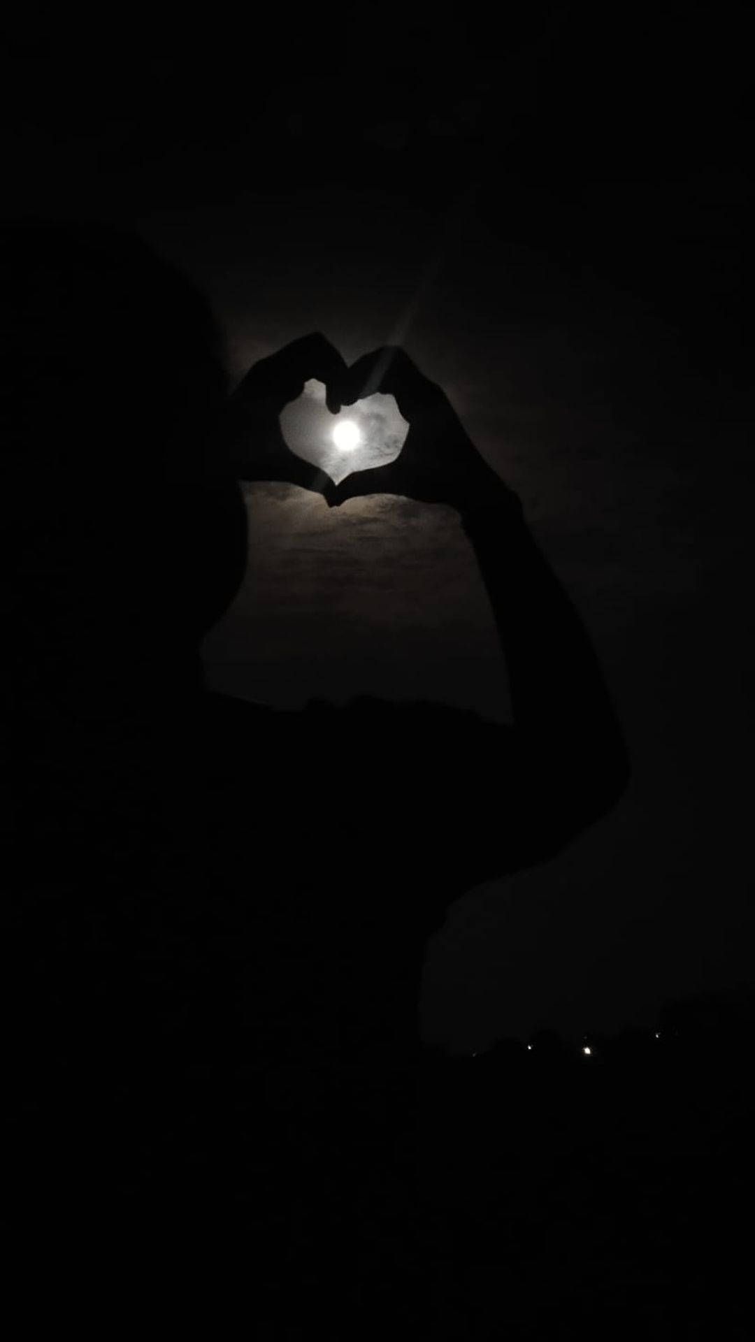 A person making the shape of heart with their hands - Black heart
