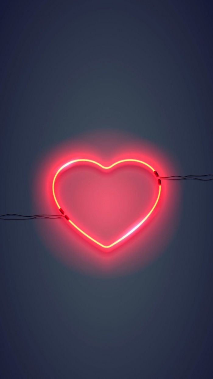 A red neon heart sign on a dark background - Black heart, love