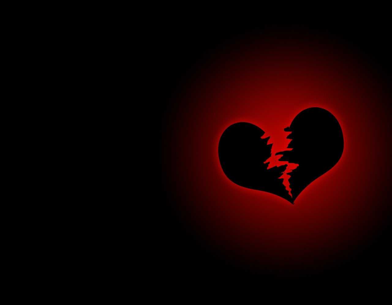 A broken heart on black background - Black heart