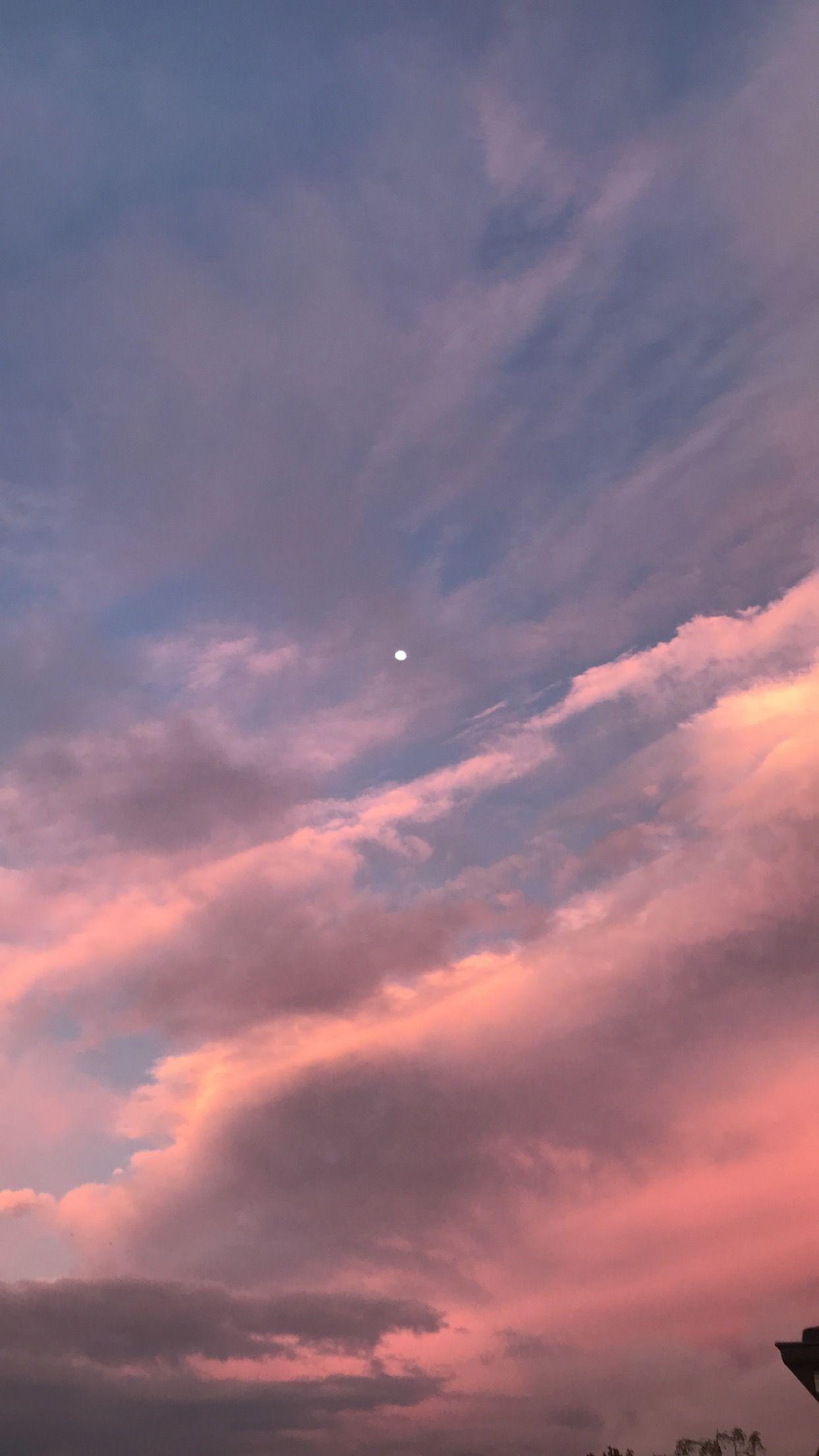 A pink and blue sky with a crescent moon. - Sky