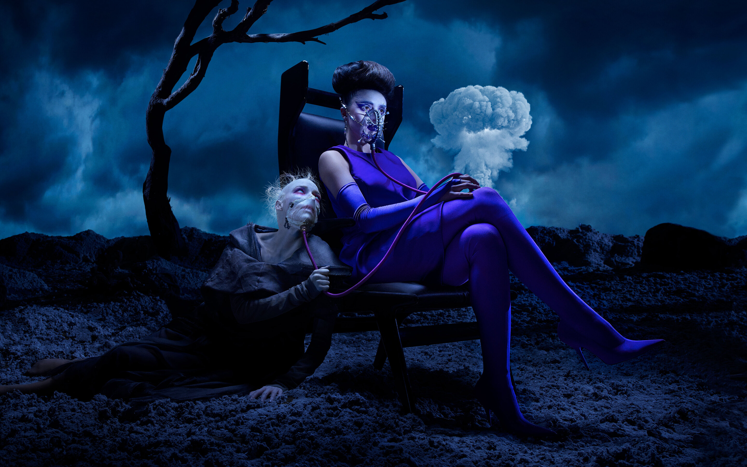 A woman in a purple dress sits in a chair in a dark landscape. - Horror