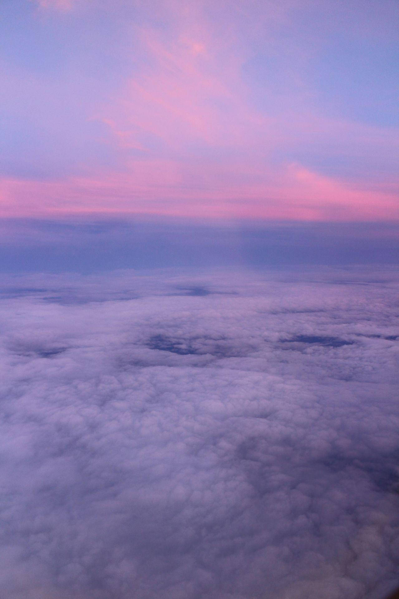 A plane flying over the clouds at sunset - Grunge, sky