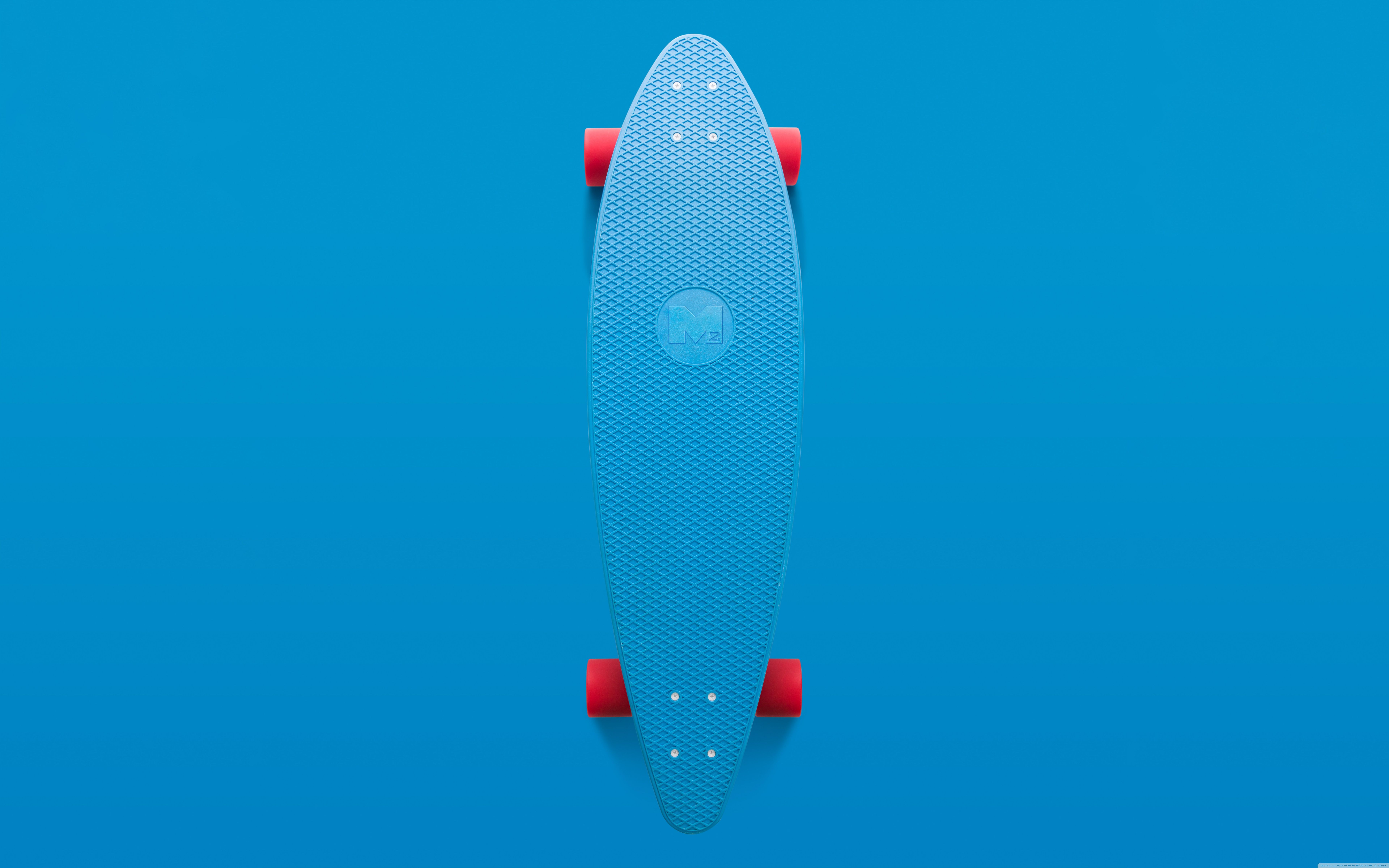A blue skateboard with red wheels on a blue background - Skater