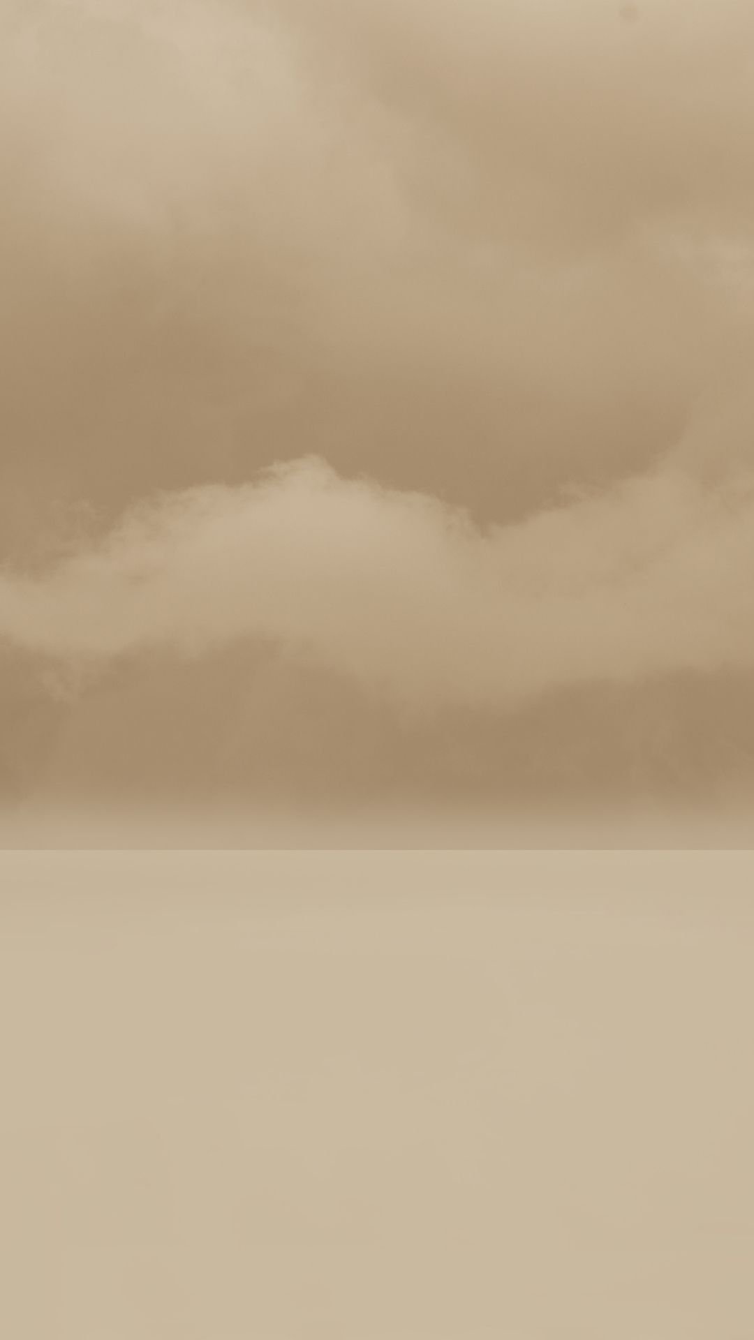 A sepia toned image of a large cloud over a large body of water - Cream