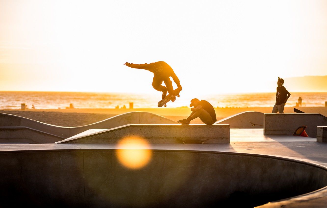 Skateboarders at a skate park in the sunset - Skate