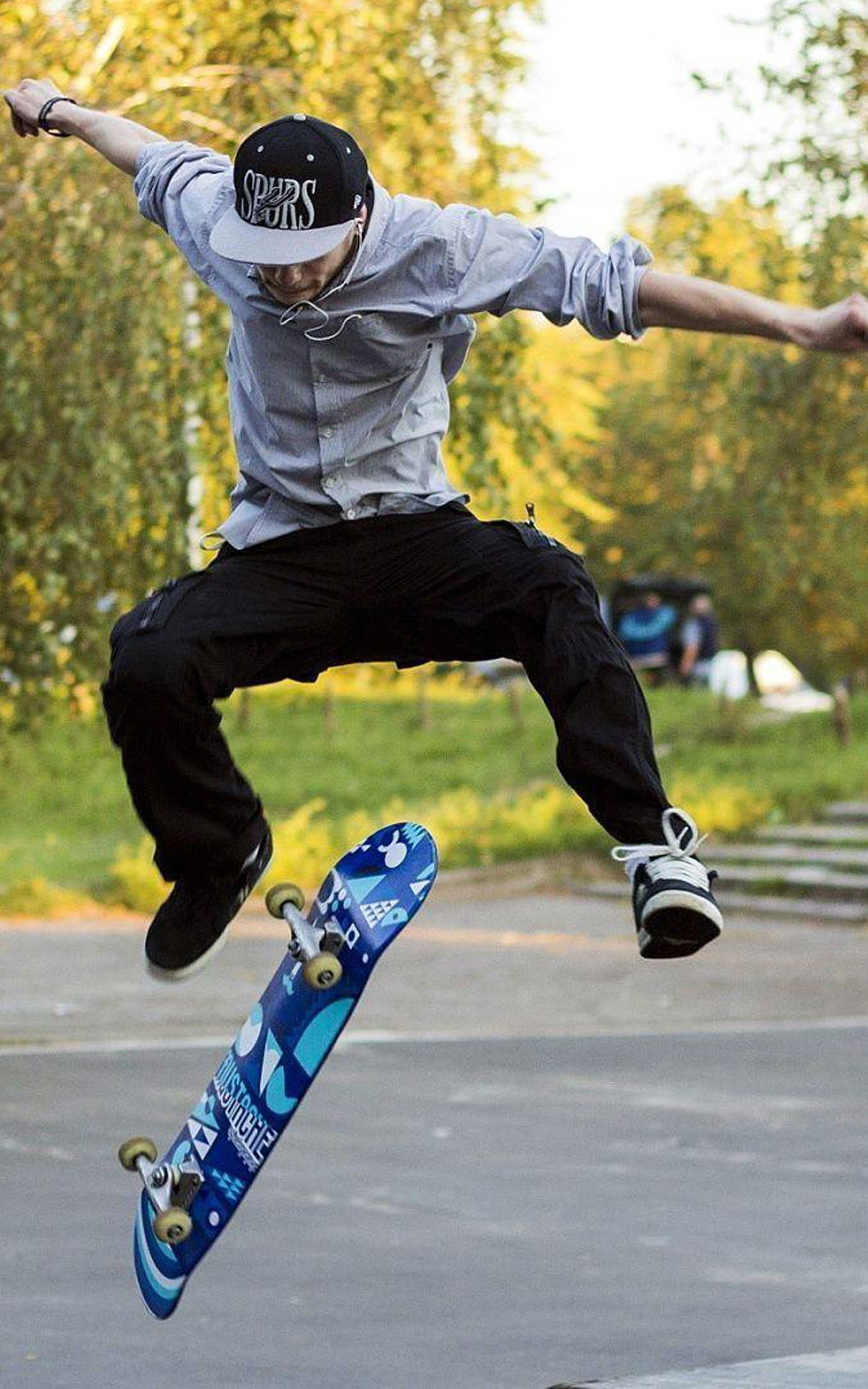 A skateboarder in the air doing a trick. - Skate