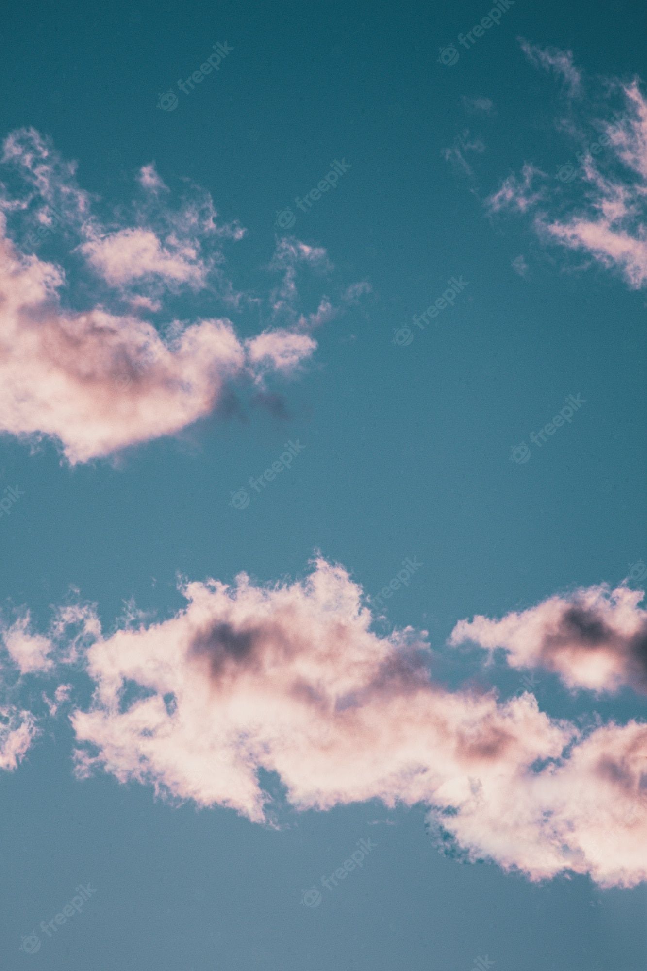 A blue sky with clouds and some pink - Vintage clouds