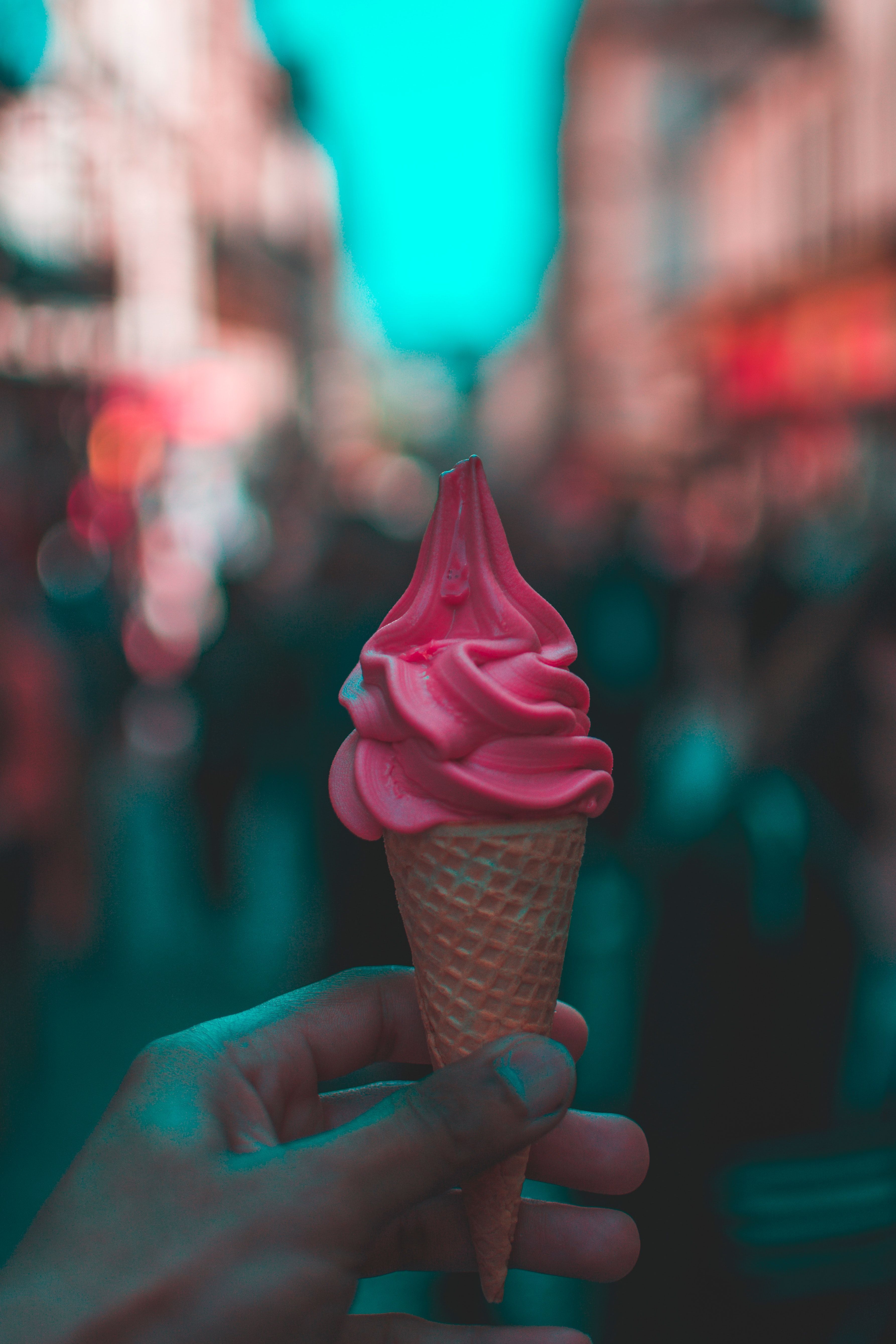 A person holding an ice cream cone in their hand - Ice cream