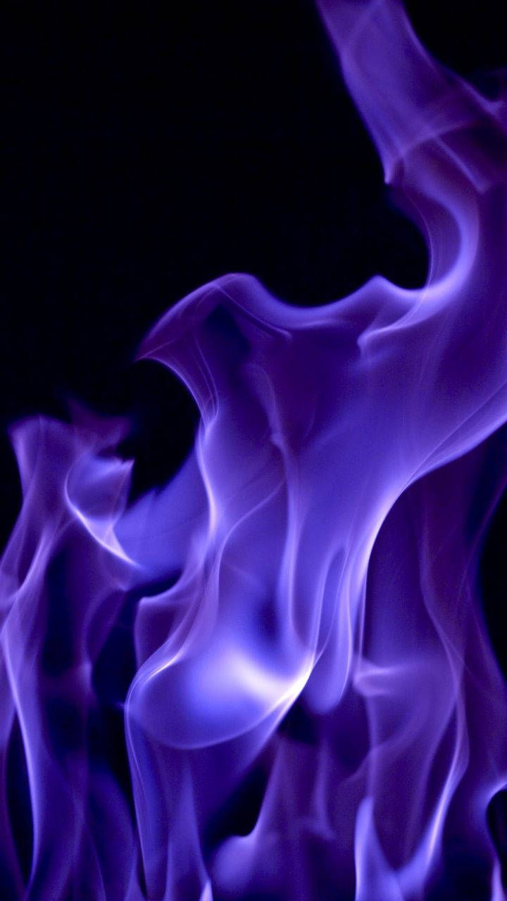 A purple flame is shown on black background - Fire, flames