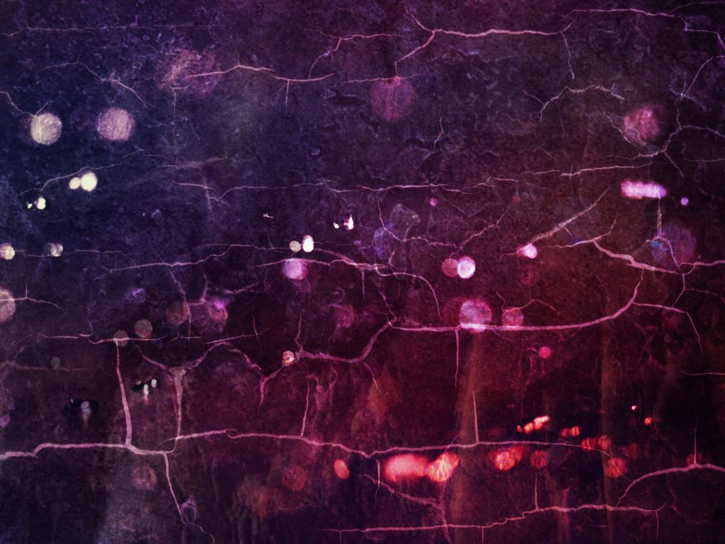 Cracked purple and pink paint on a wall with light shining through. - Grunge
