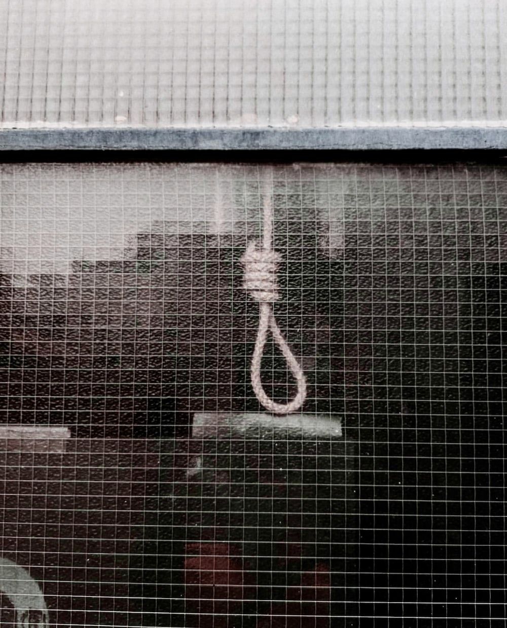 A noose hanging from a window - Grunge