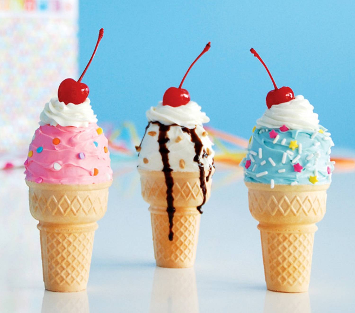 Three ice cream cones with whipped cream and a cherry on top - Ice cream