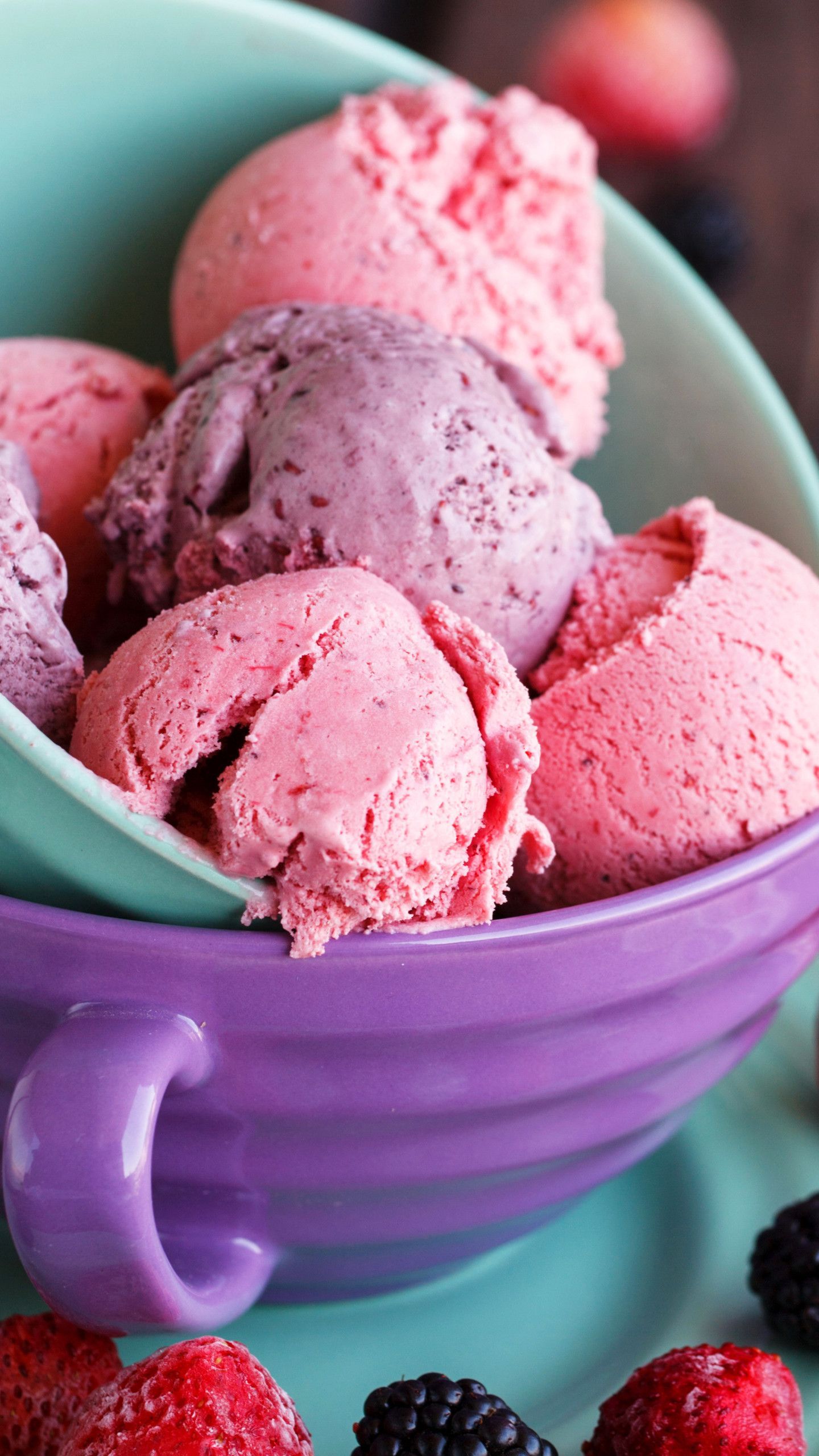 A purple bowl full of scoops of mixed berry ice cream. - Ice cream