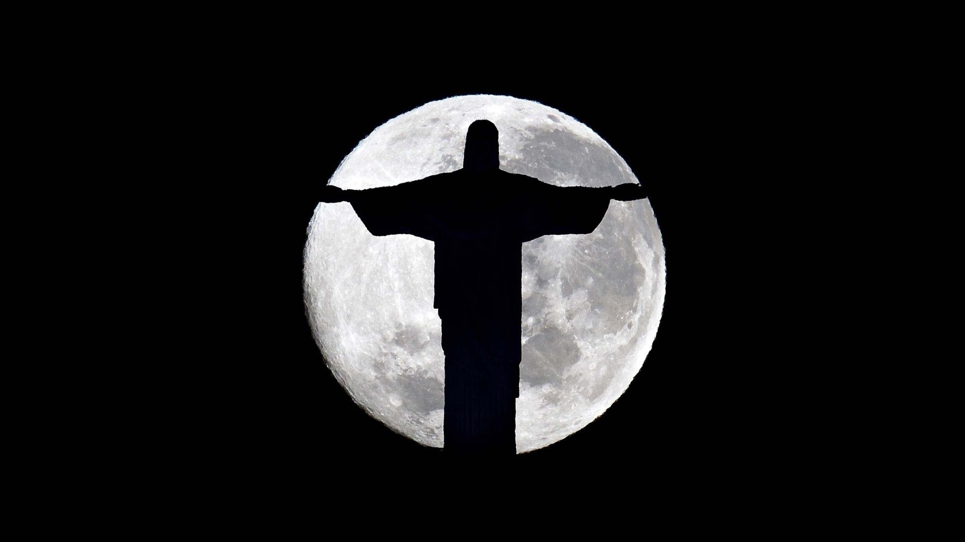 The silhouette of jesus on a hill with moon in background - Jesus