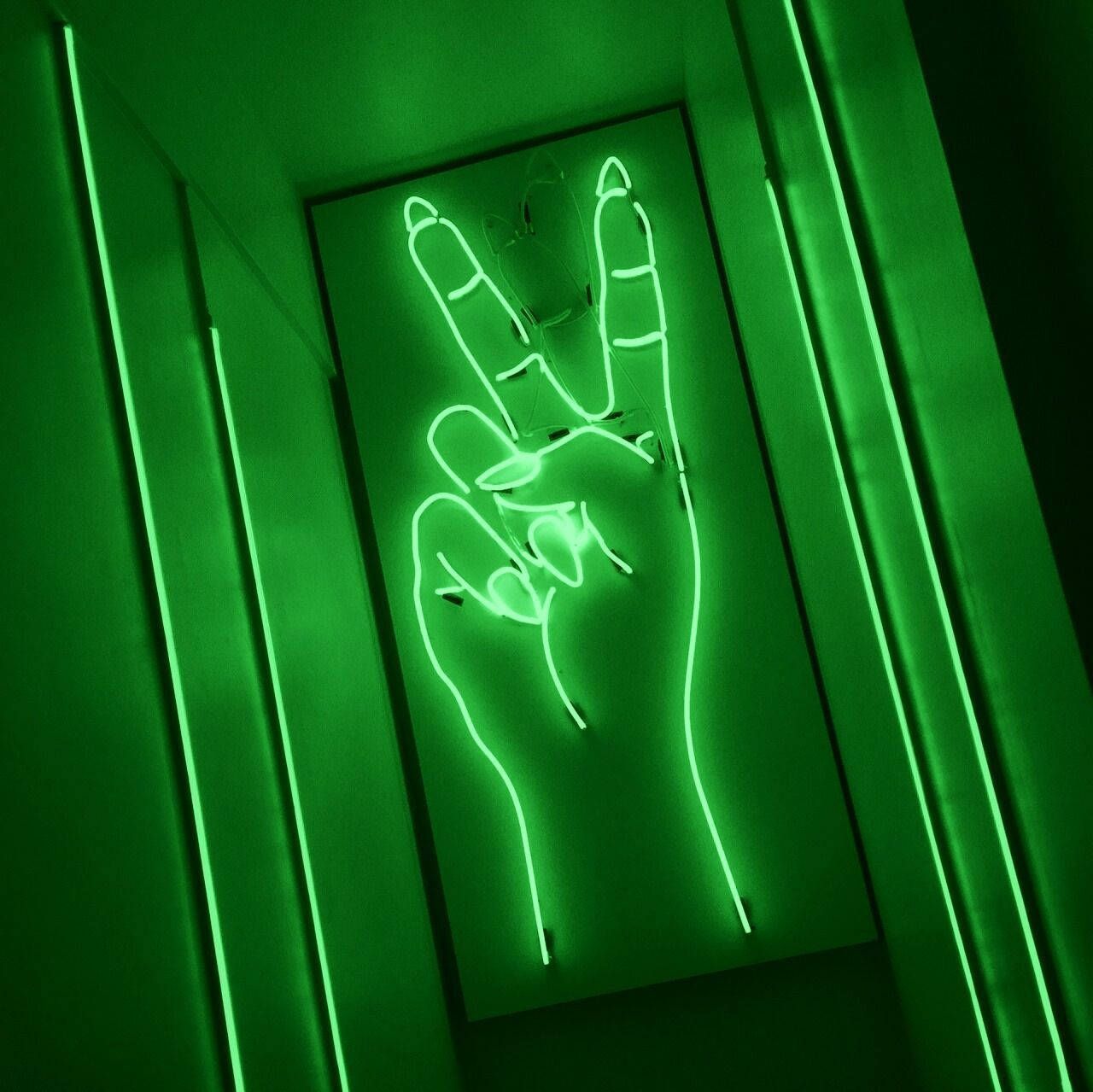 A neon sign of a hand making the peace sign - Green, neon green, peace