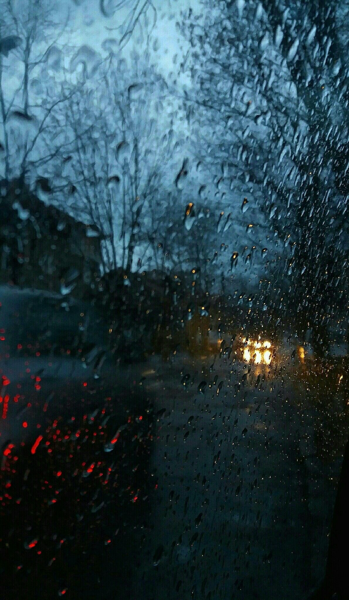 A car driving down the street in rain - Rain