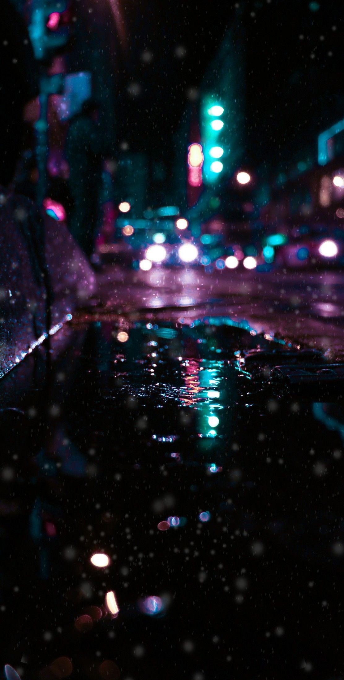A city street with cars and lights - Rain