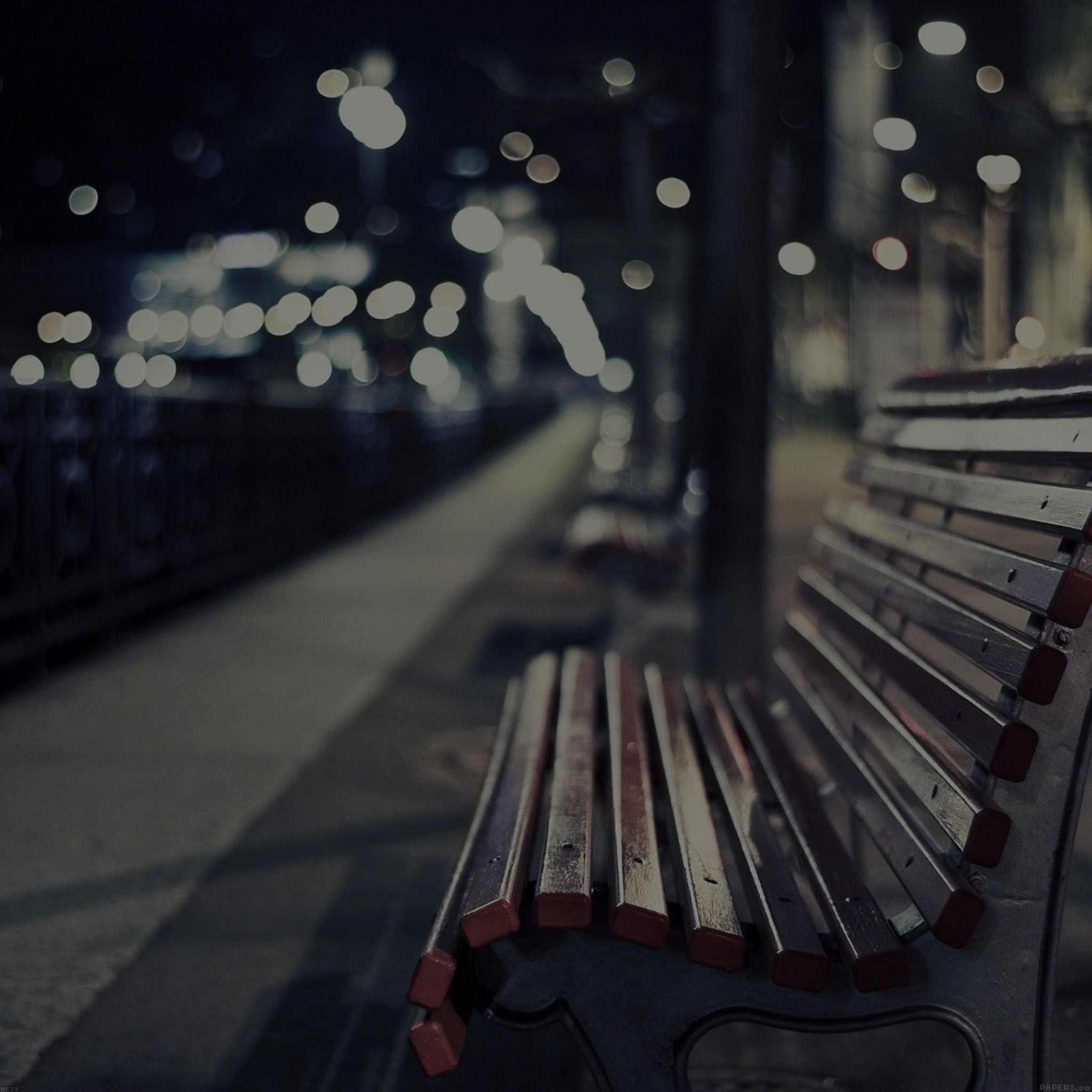 A wooden bench on the street - Night