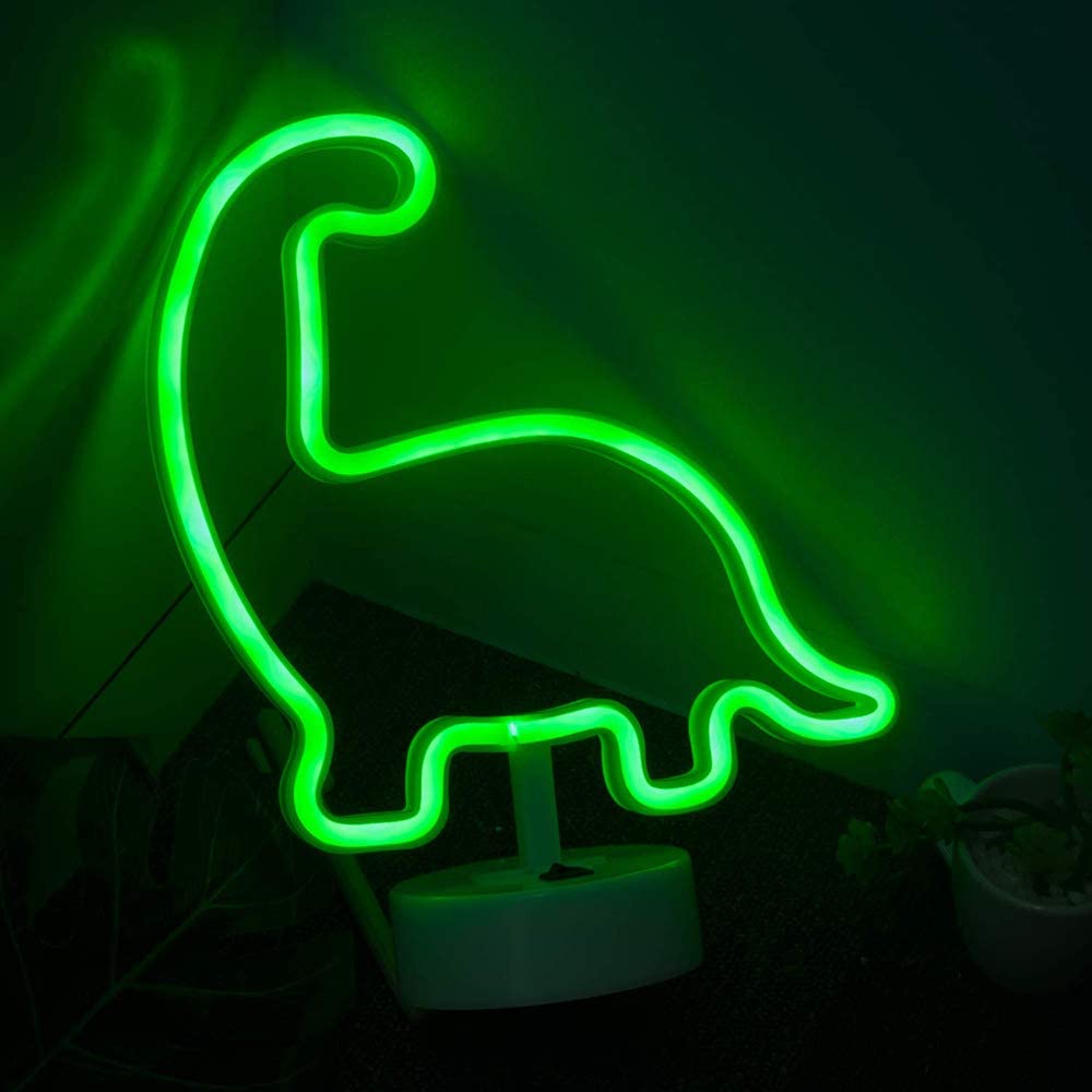 A green dinosaur shaped light on the wall - Neon green