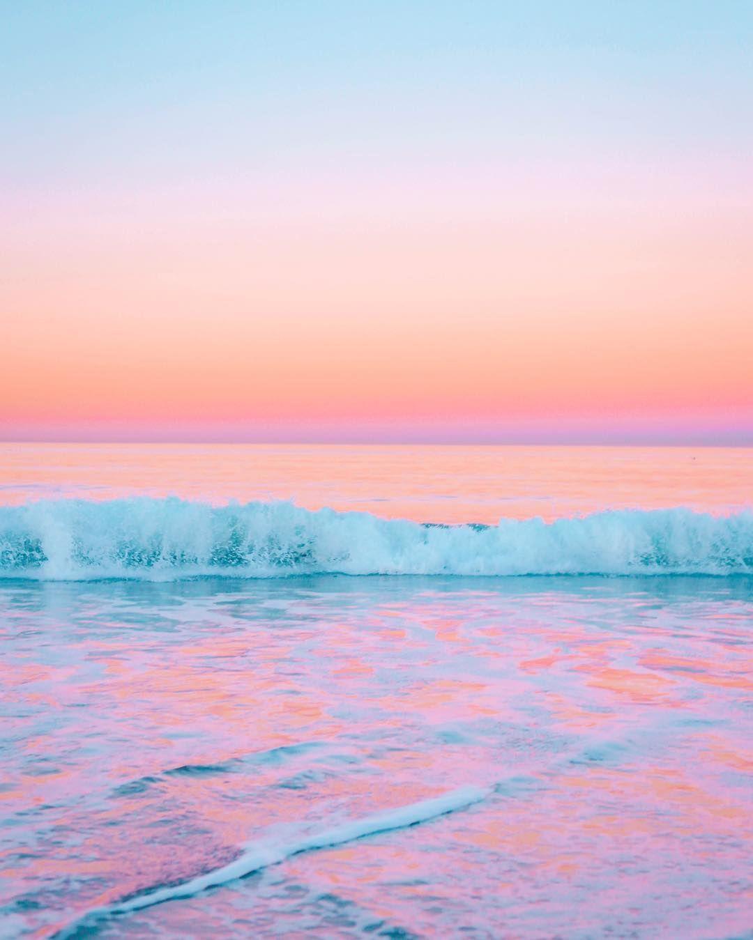 IPhone wallpaper of a sunset over the ocean with pink and blue colors. - Ocean