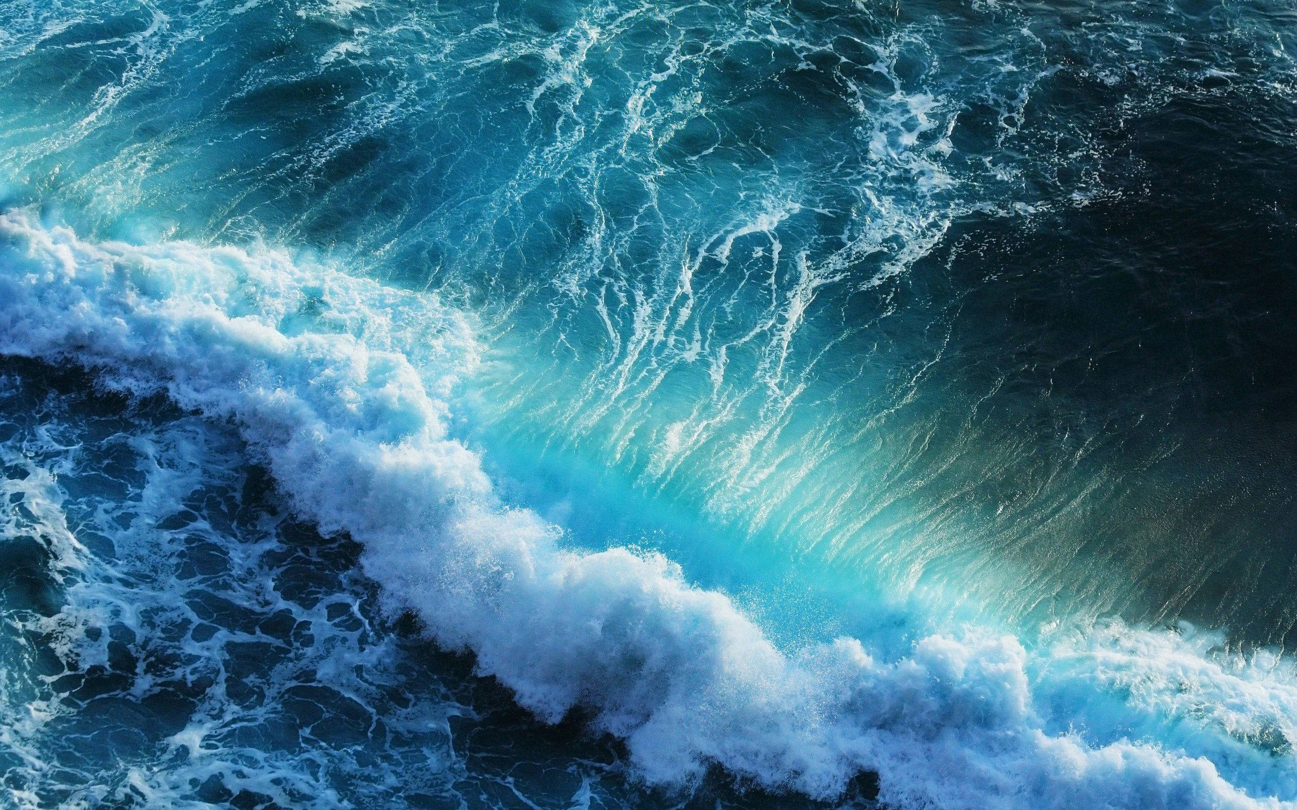 An aerial view of a blue ocean with waves - Ocean, wave