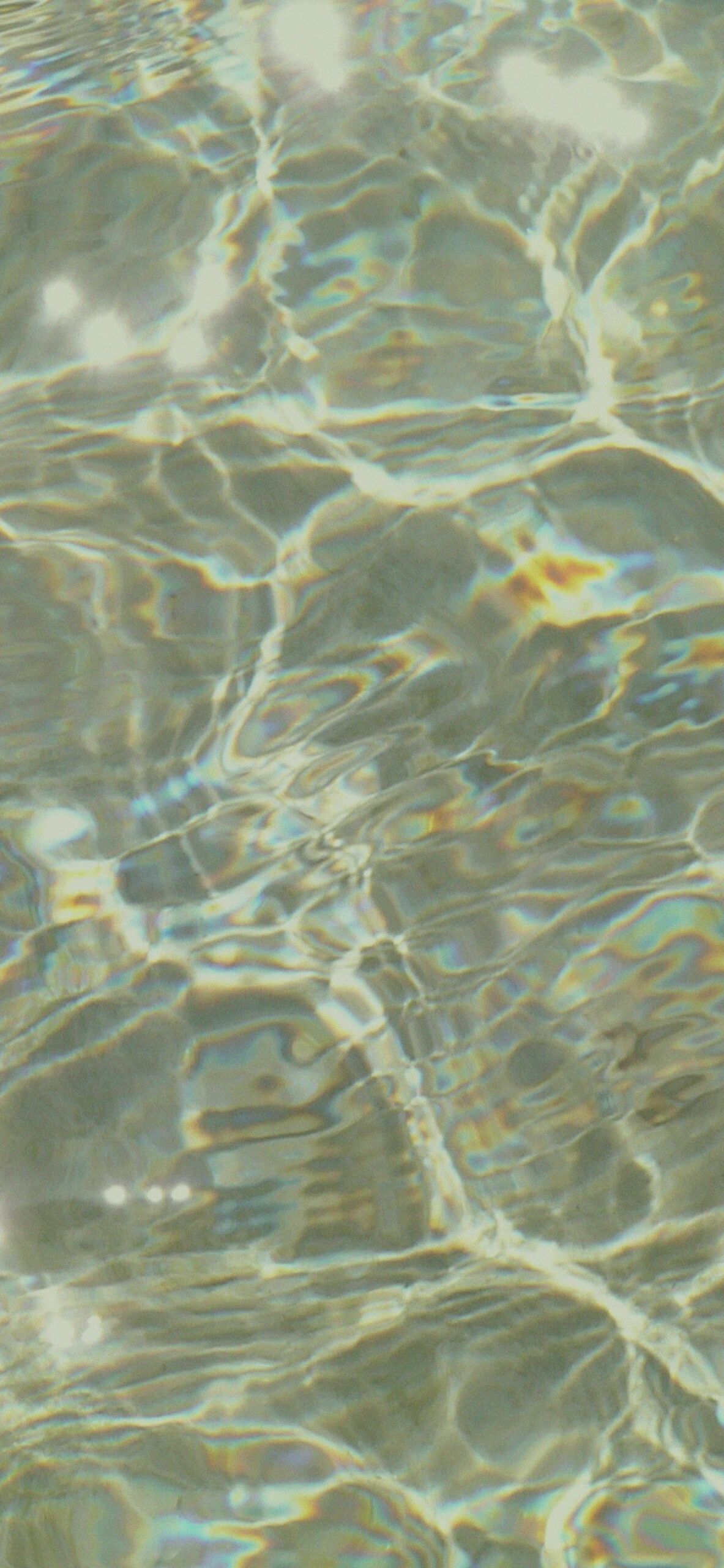 A close up of a body of water with light reflecting off the surface. - Soft green, forest, light green, pastel green