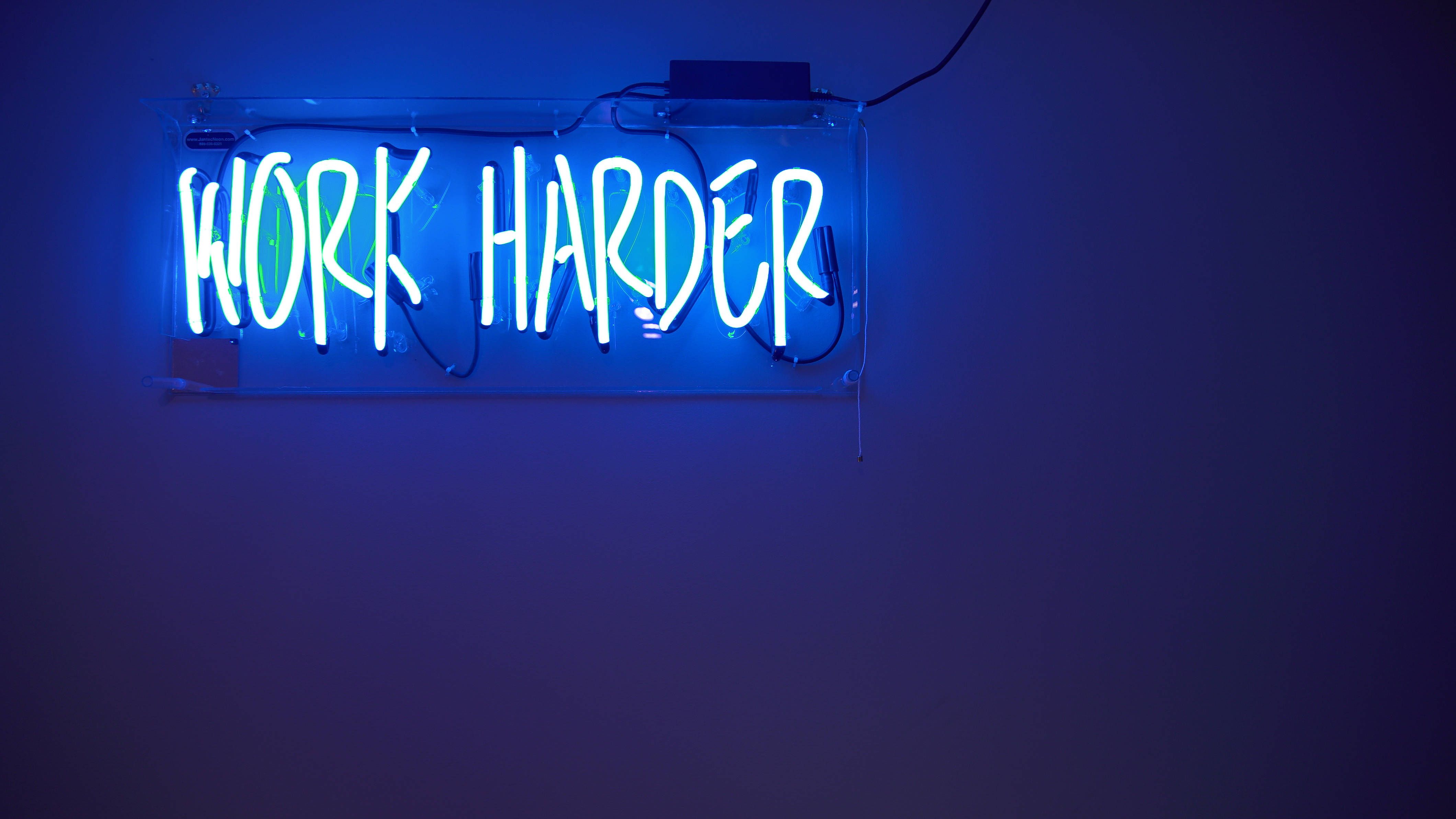 A neon sign that says work harder - Neon blue, gym