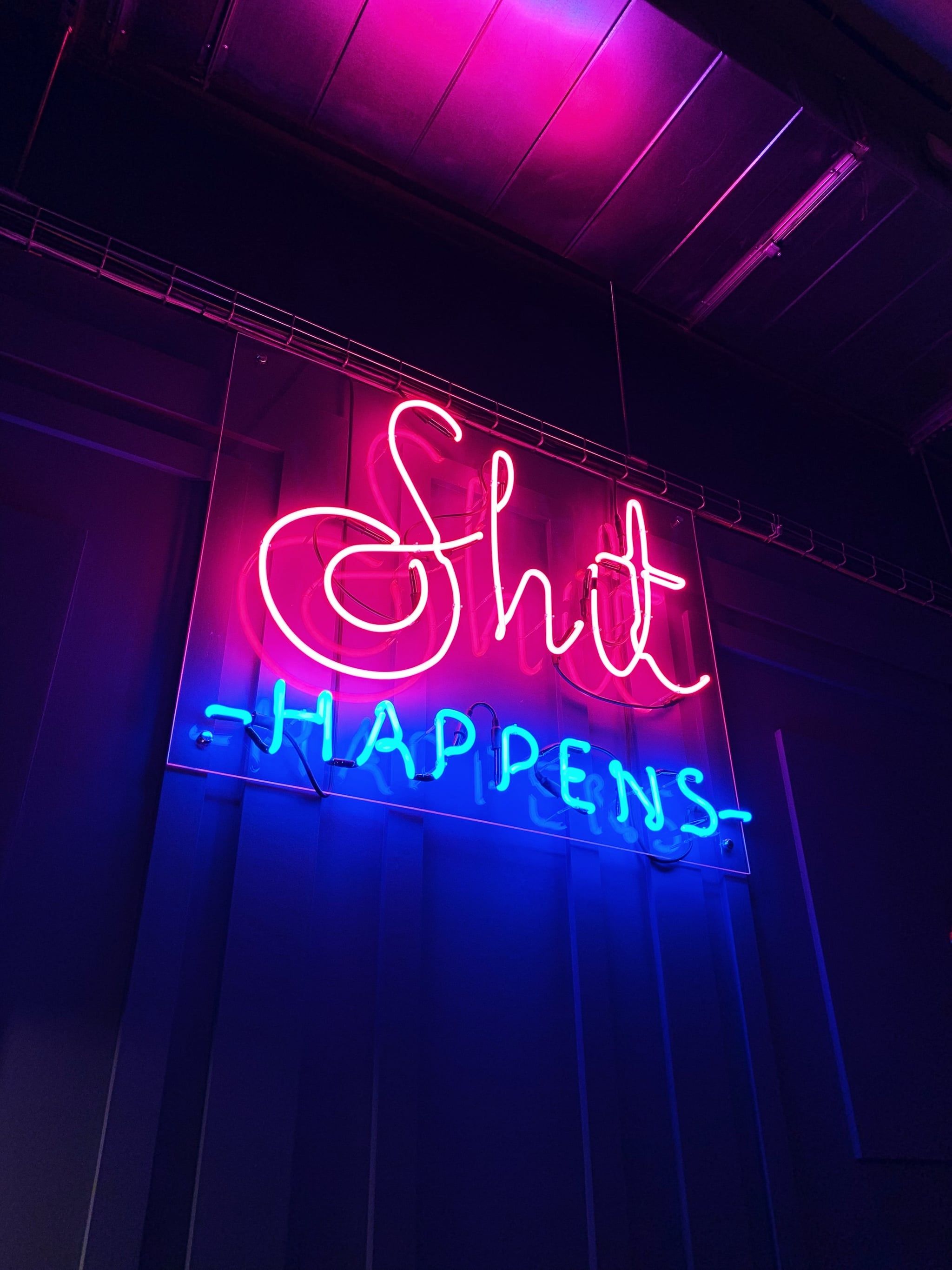 A neon sign that says shit happens - Neon blue