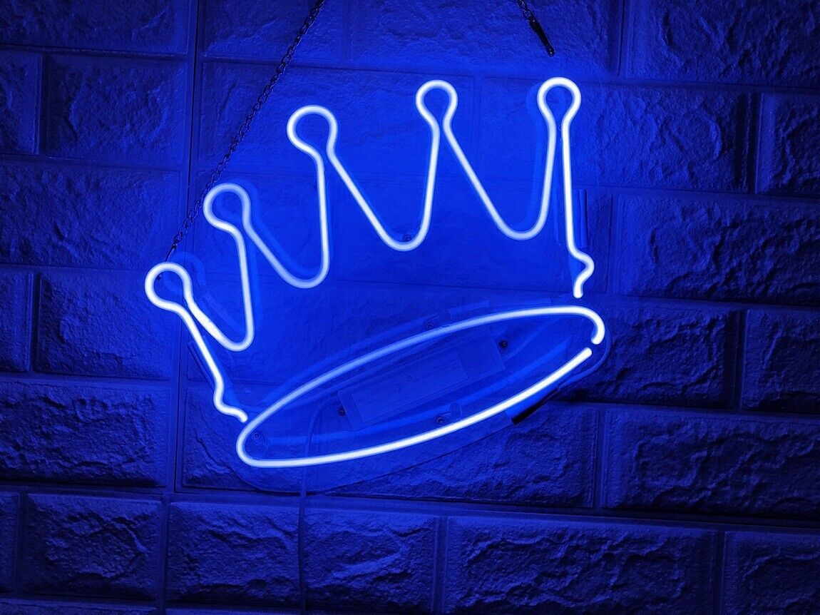 A neon sign of the crown is hanging on brick wall - Neon blue