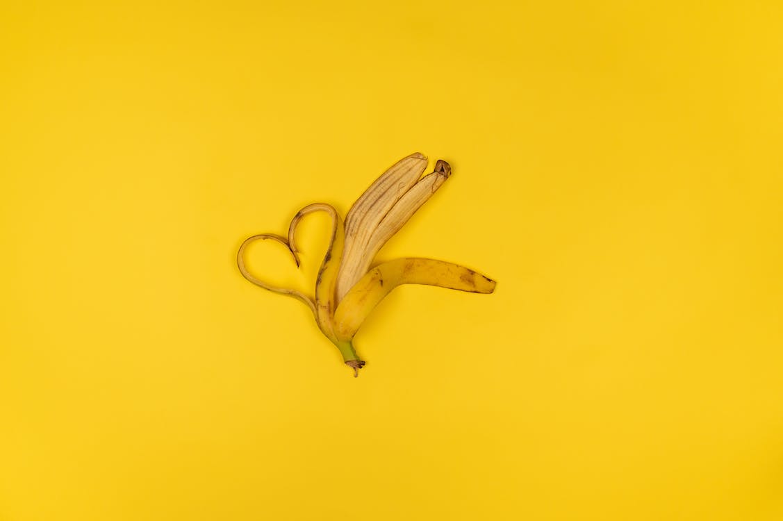 A banana peel on a yellow background - Banana