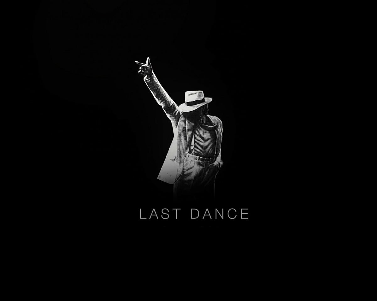 A black and white image of Michael Jackson performing with the words 