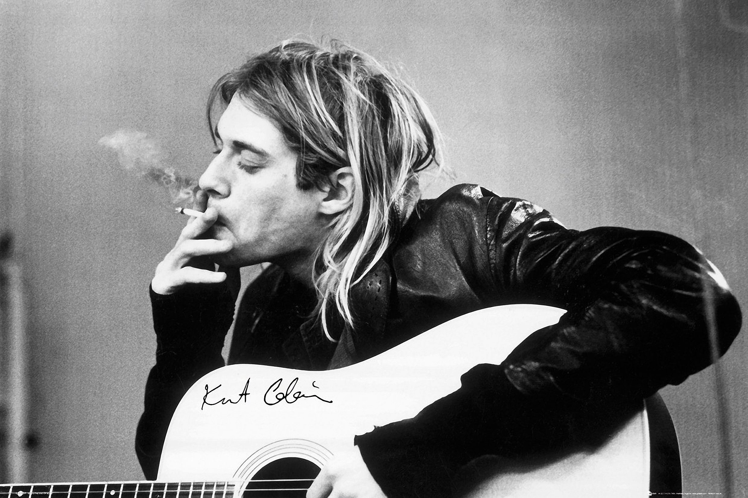 A black and white image of Kurt Cobain playing a guitar and smoking a cigarette. - Nirvana