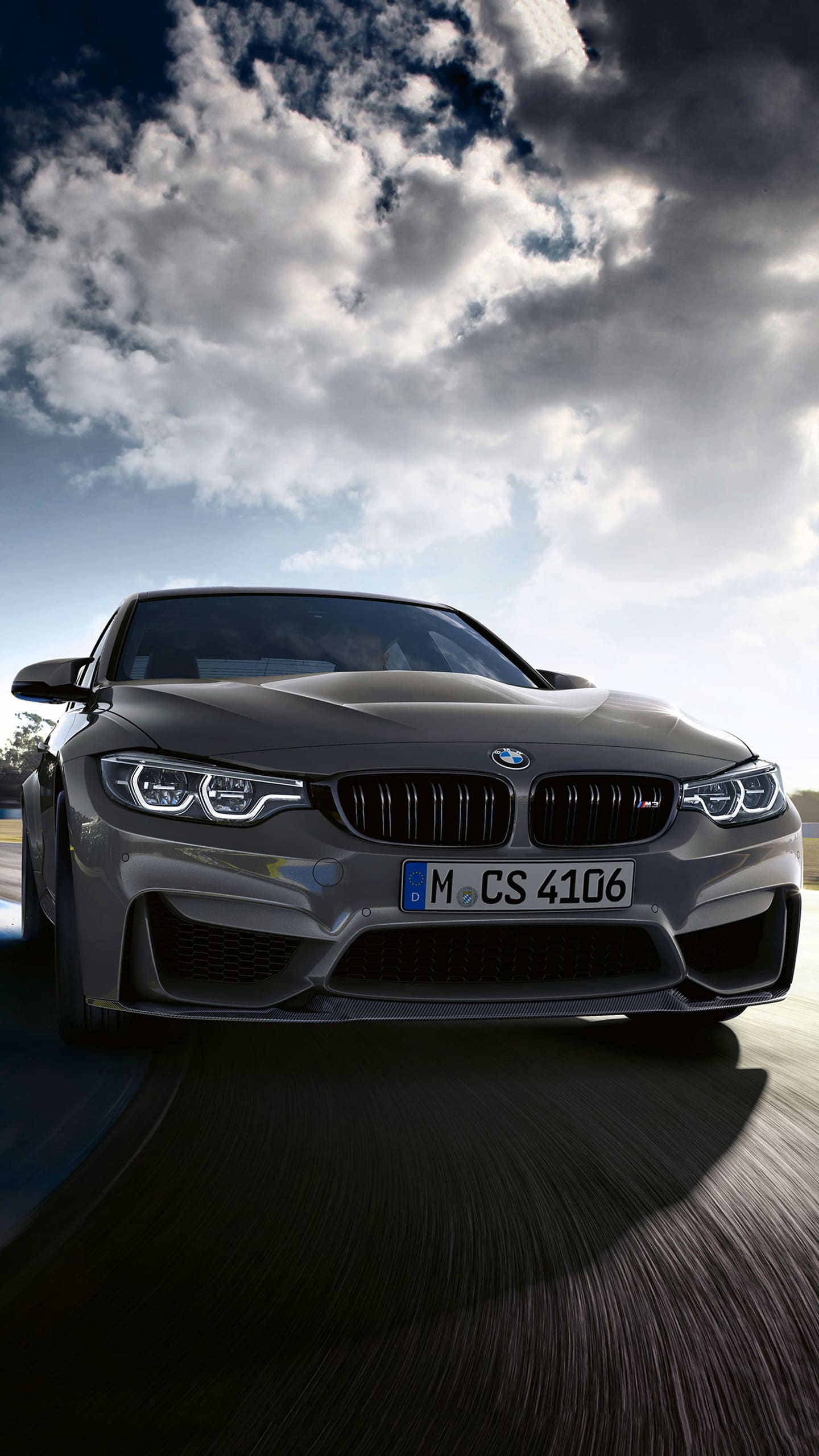 Front view of a BMW M4 CS on a race track - BMW