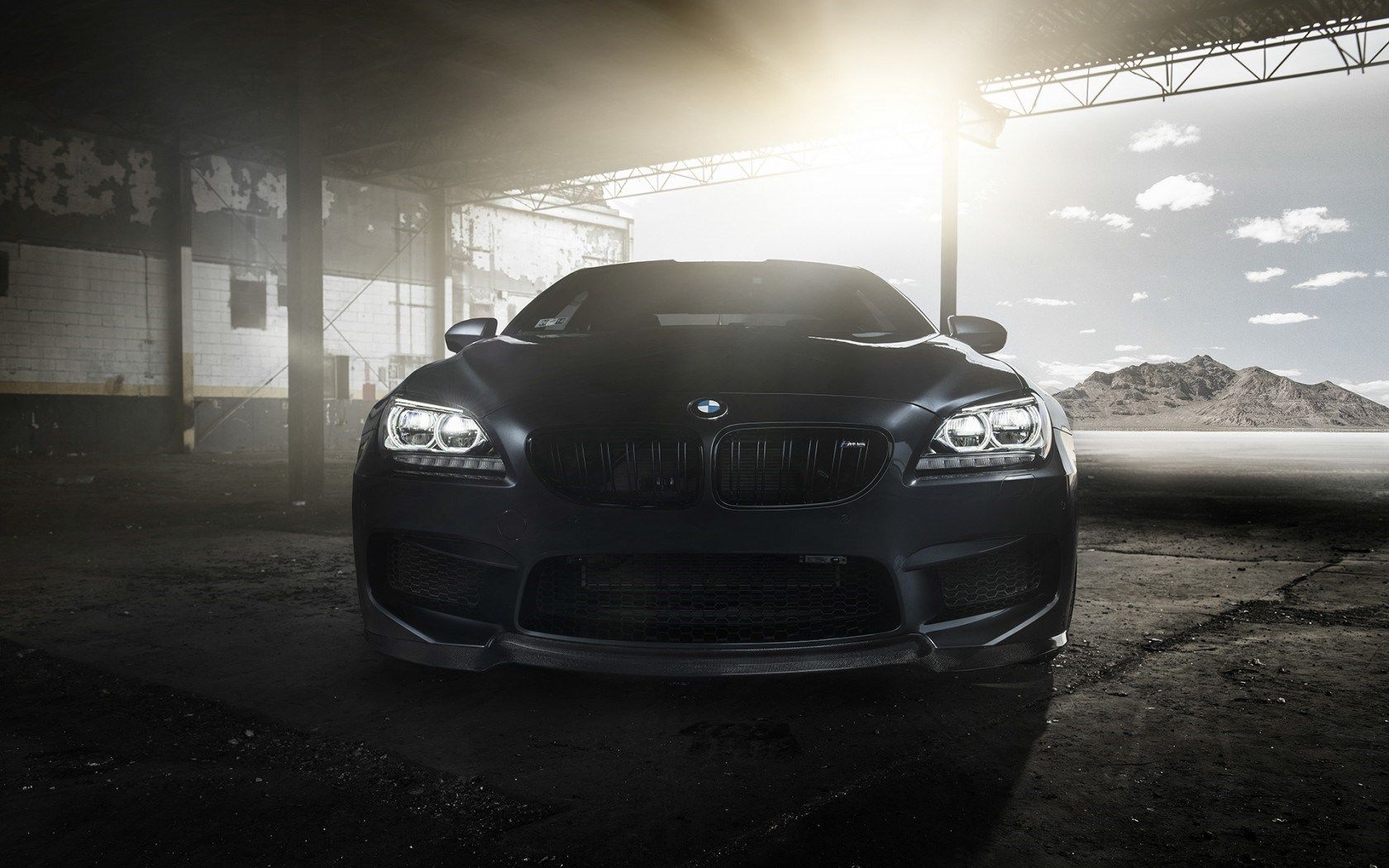 A black car parked in an empty garage - BMW