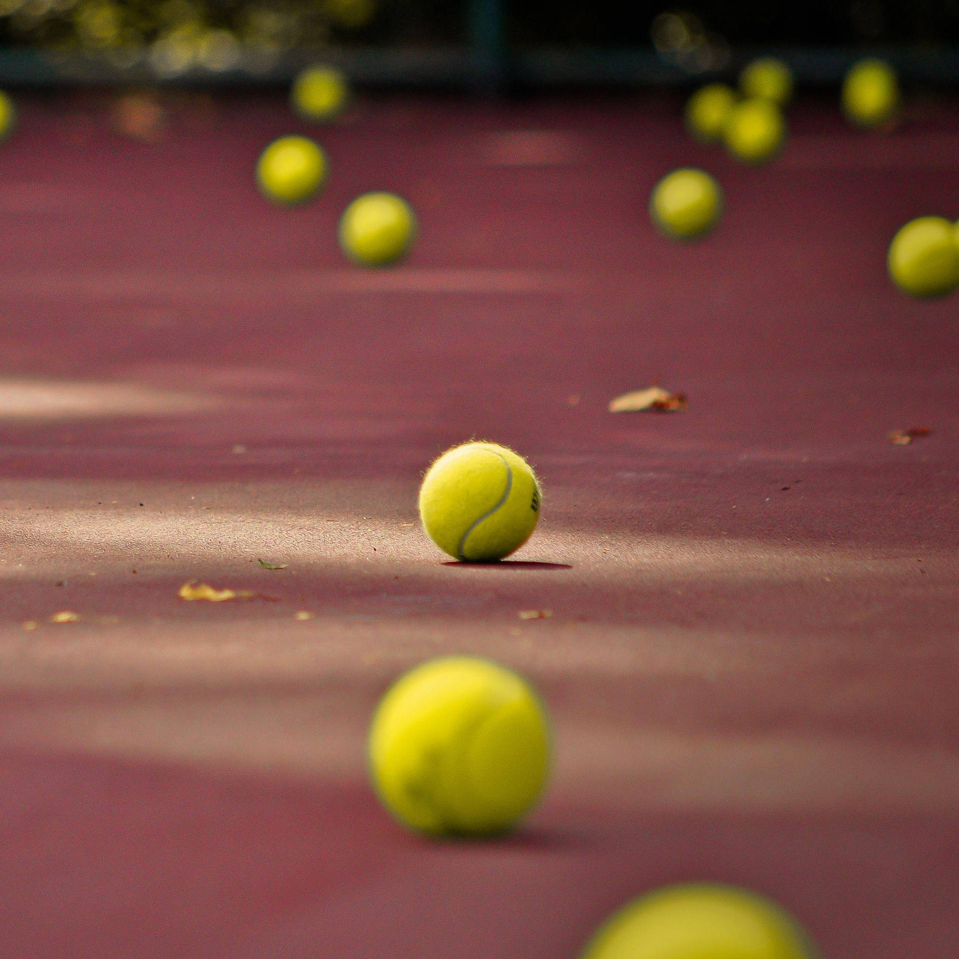 A tennis ball sits on a tennis court - Tennis