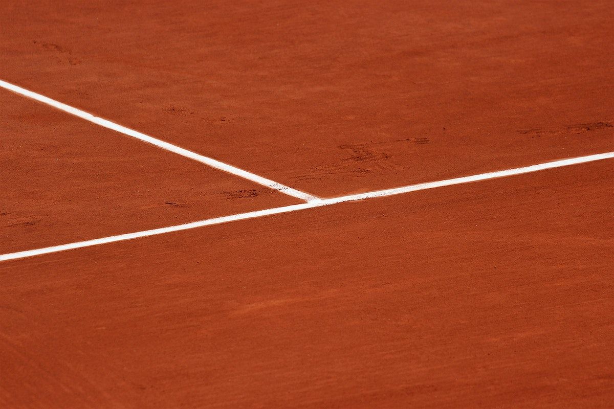 A close up of a tennis court with white lines. - Tennis