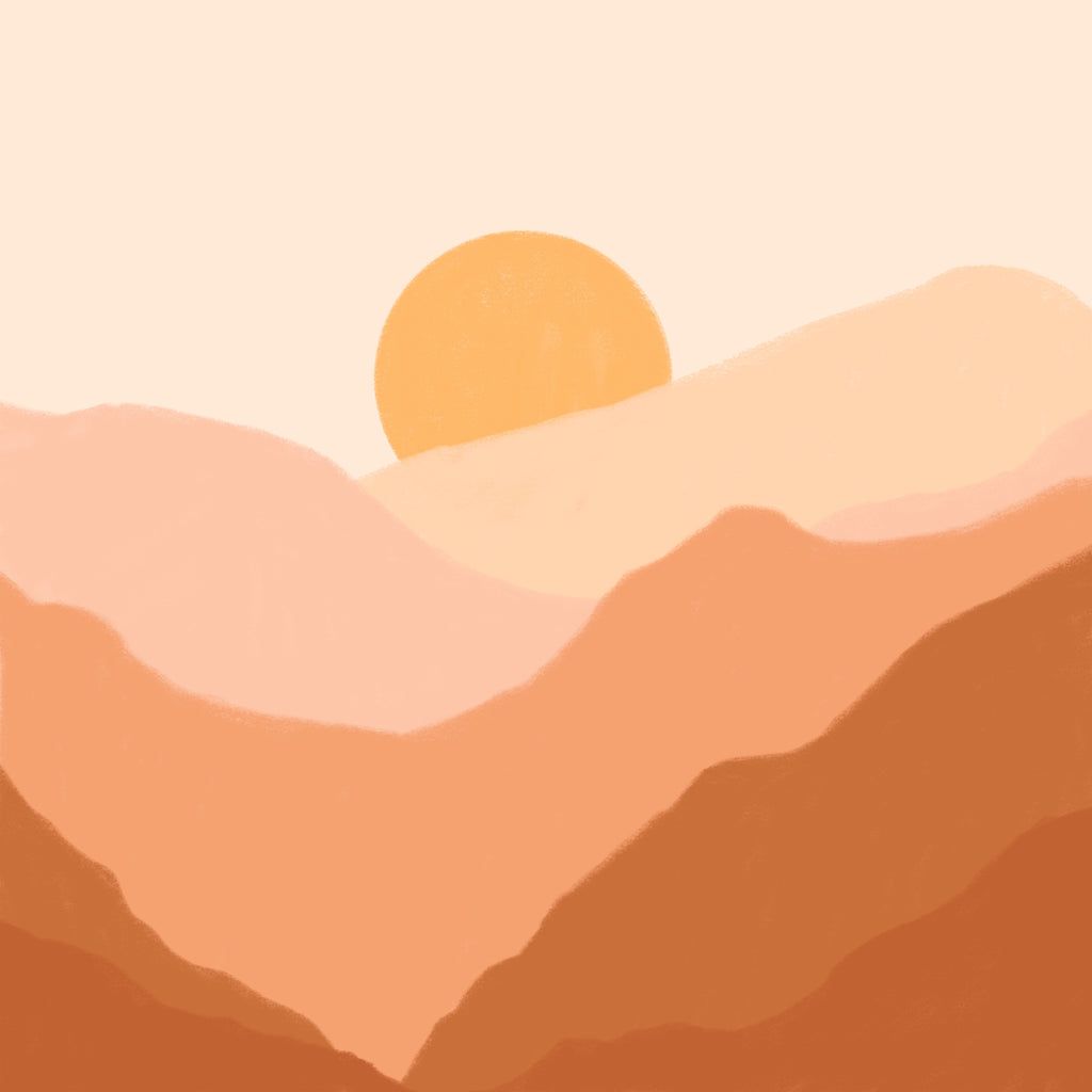 A sunset over the mountains in an orange sky - Boho