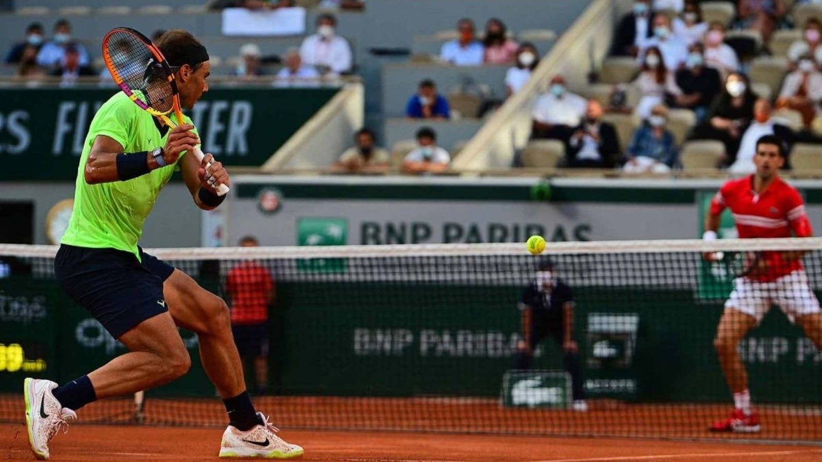 A man playing tennis on the court with another person - Tennis