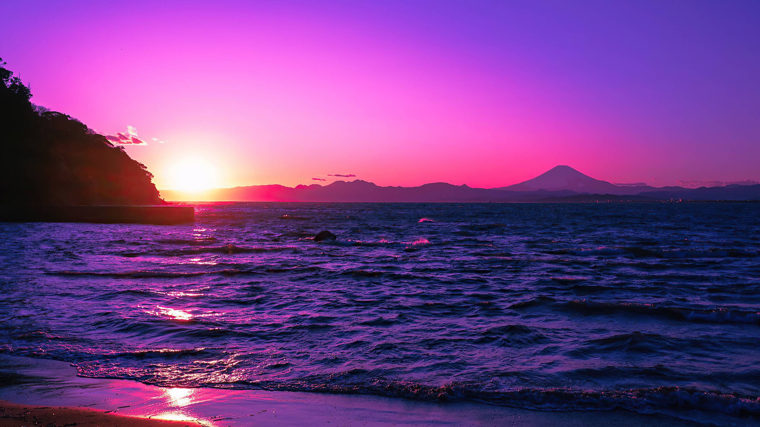 A sunset over the ocean with mountains in background - Sunset