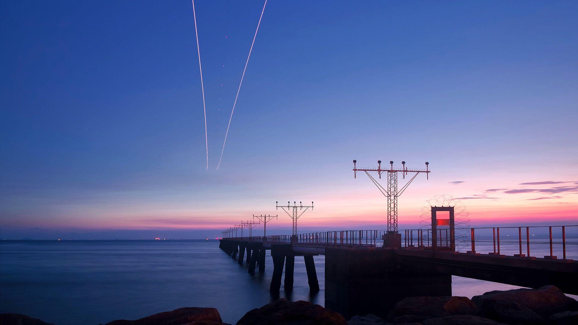 A pier with lights and airplanes in the sky - Sunset, 1920x1080, HD