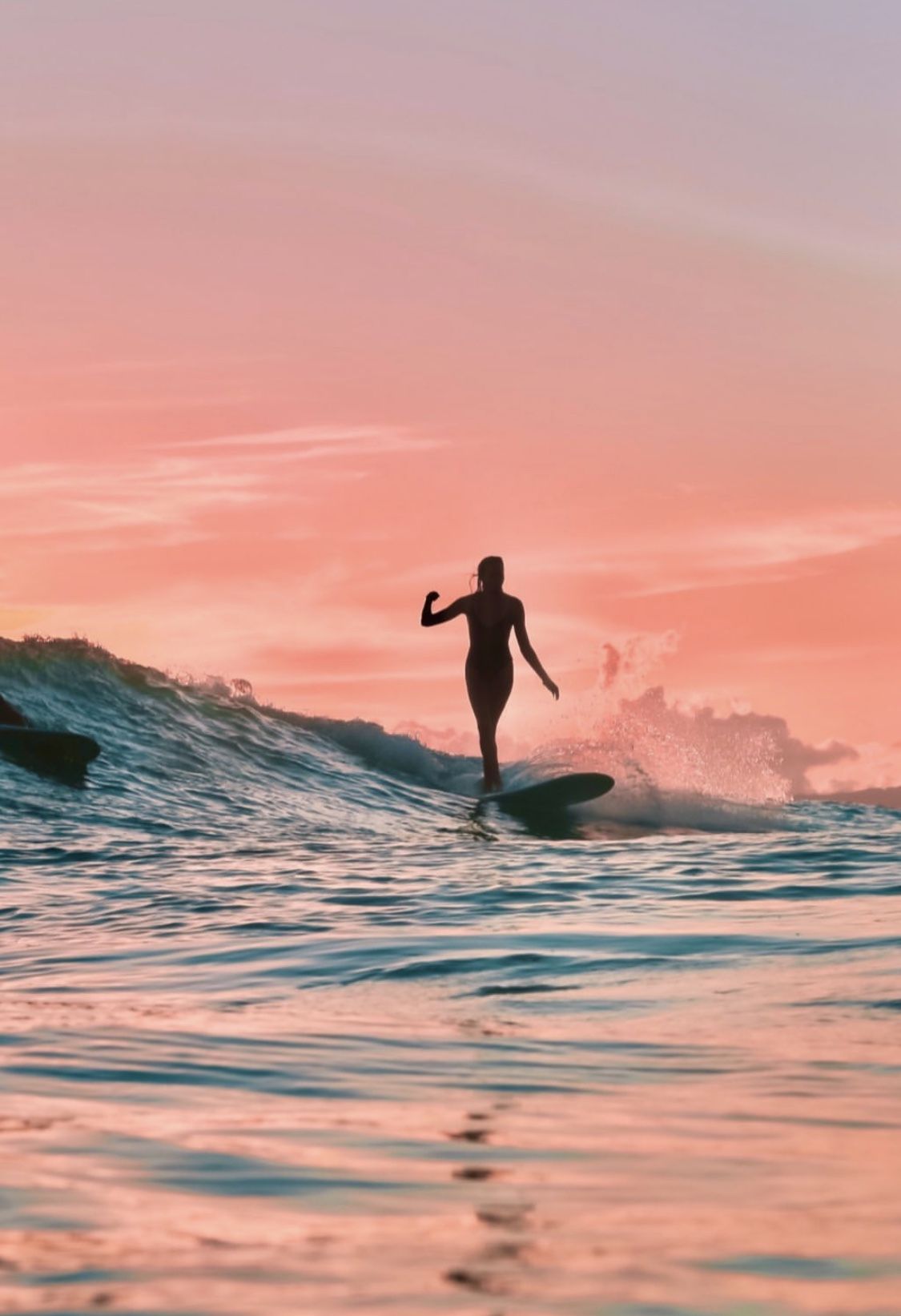 A person riding a surfboard on top of a wave. - Surf