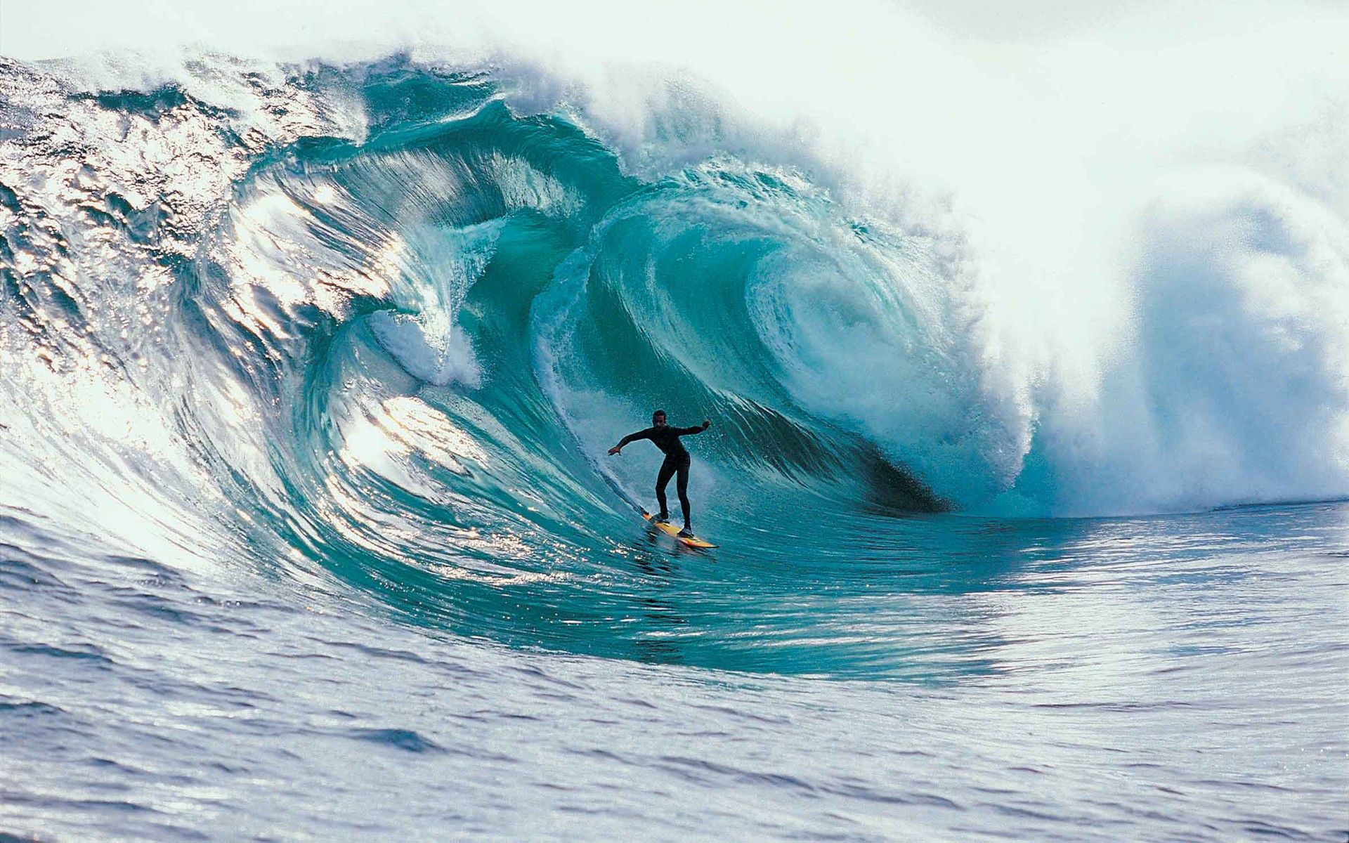 A man riding on top of an ocean wave - Surf