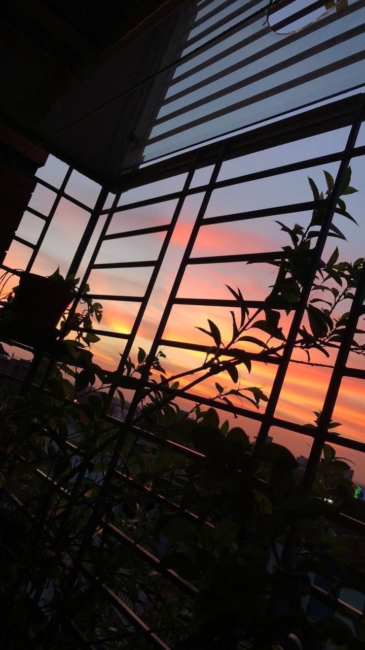 A beautiful sunset through the window of a building - Sunset