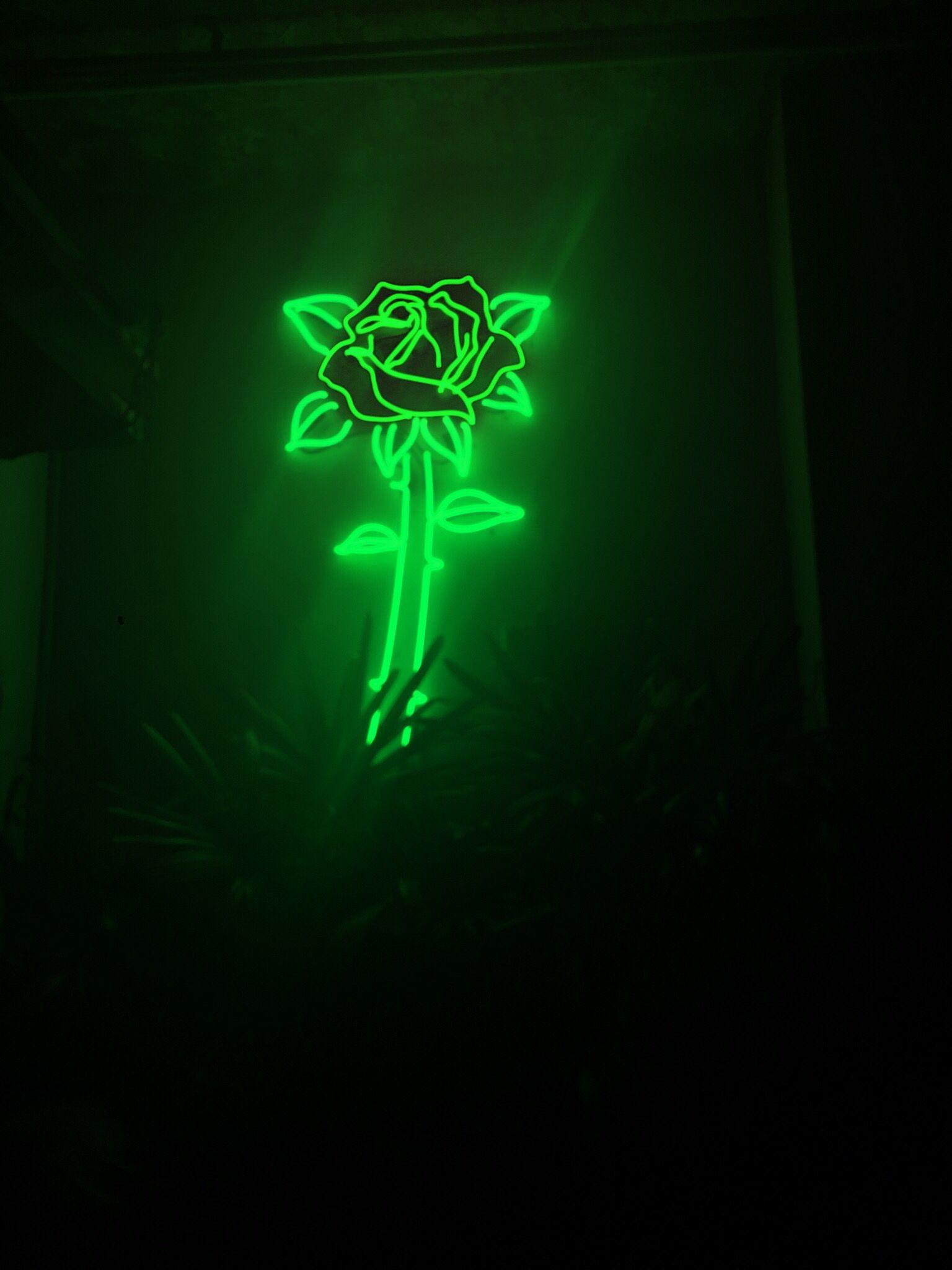 A green neon sign of a rose in a dark room. - Dark green, neon green, lime green
