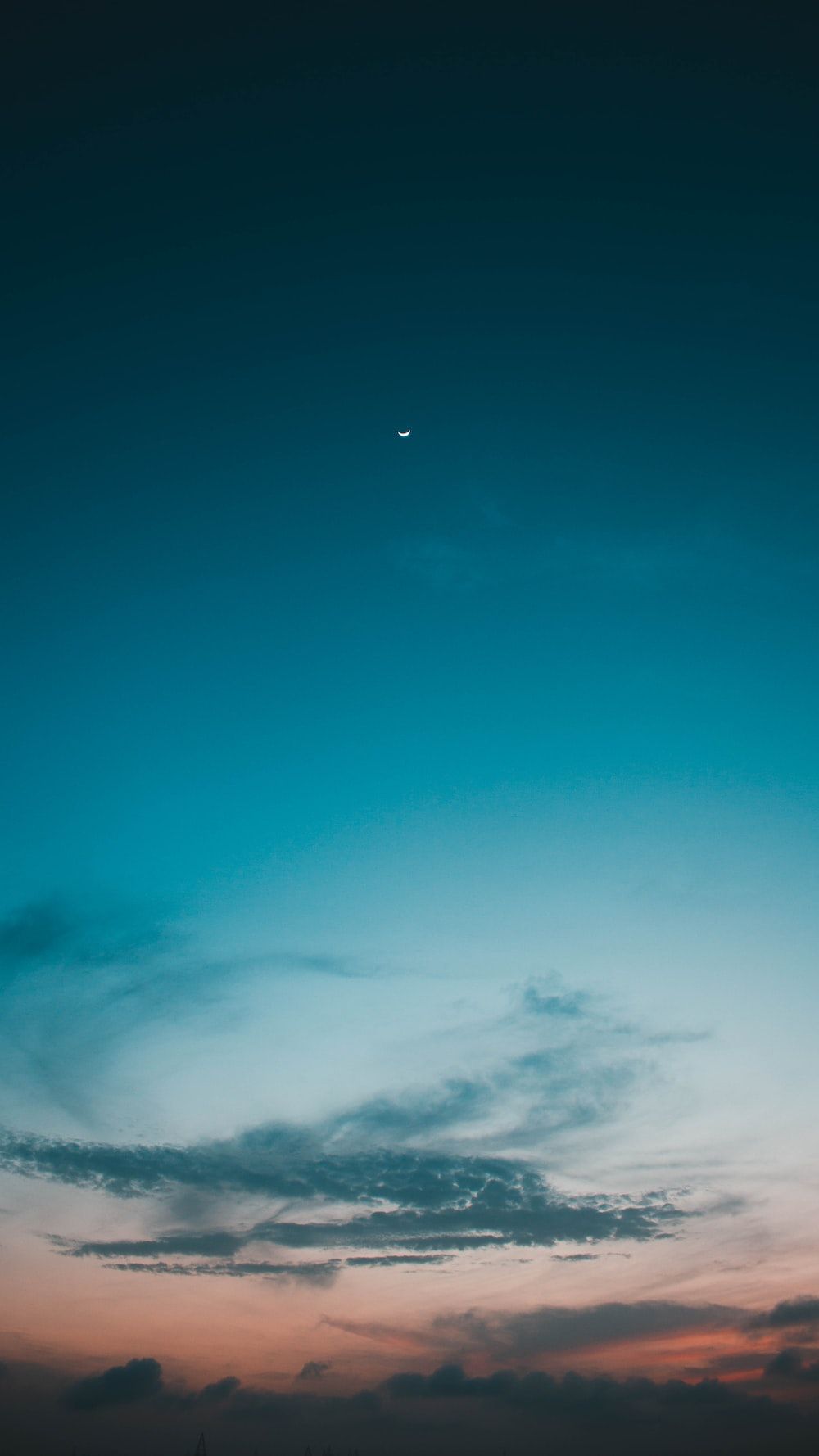 A blue sky with a crescent moon in the distance - Cyan, illustration