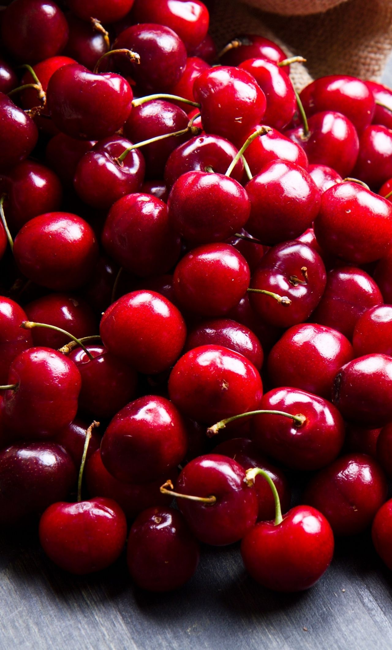 A bunch of cherries sitting on top each other - Fruit