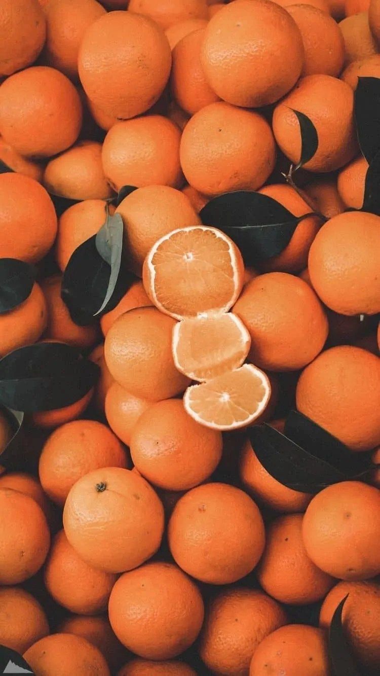 A pile of oranges with a few cut in half. - Fruit, pastel orange